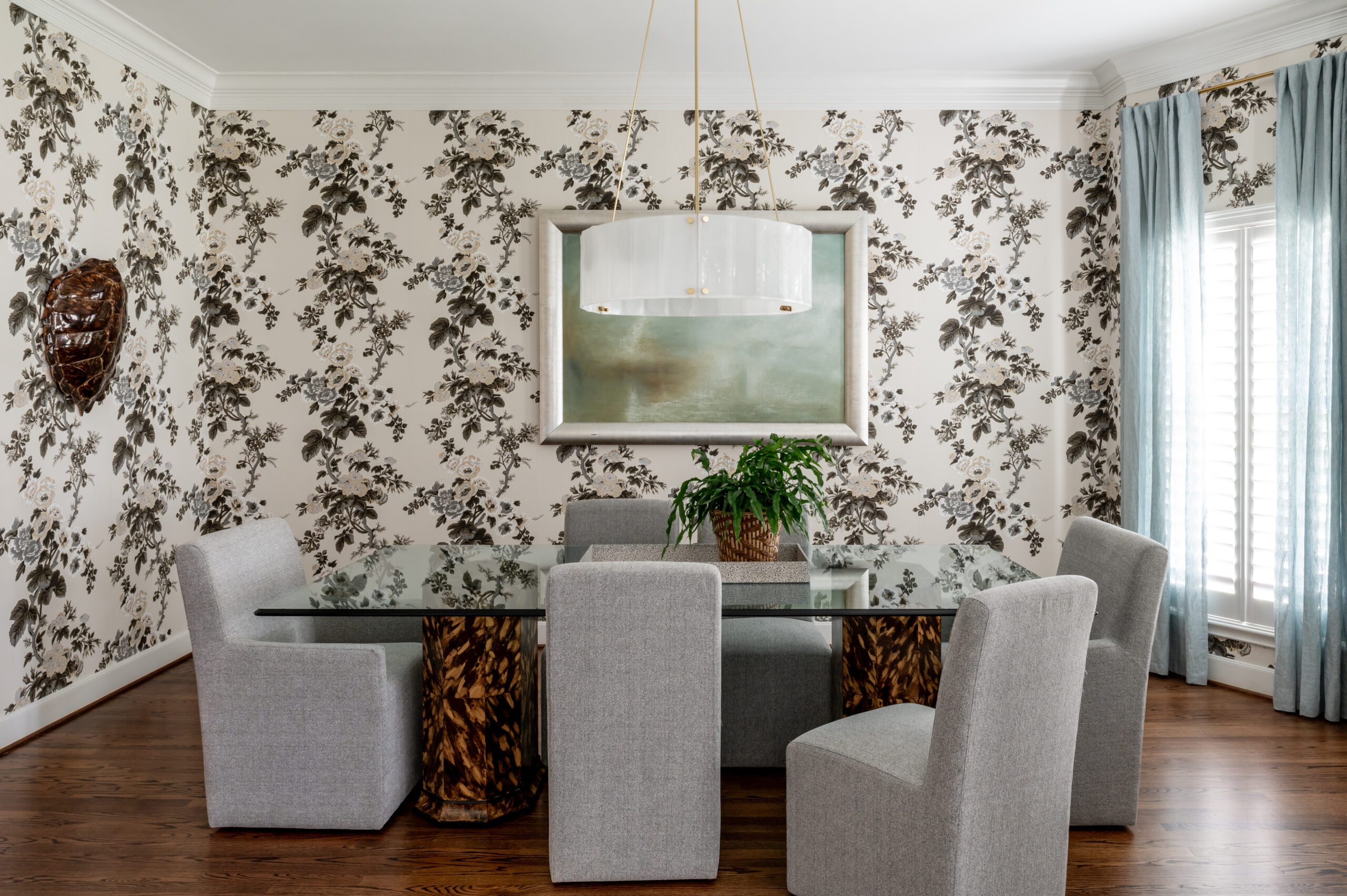 Dining room interior design photo of dream wallpaper, paired with custom-painted table bases in a tortoiseshell pattern