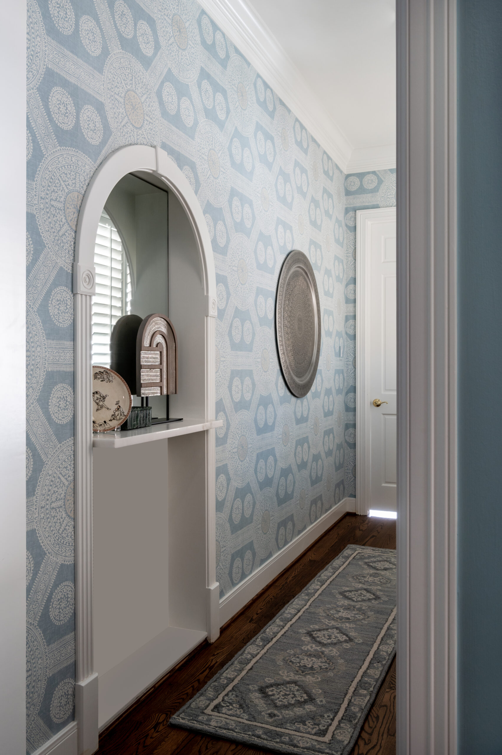 Hallway interior design photo of gorgeous blue wallpaper and styled shelves