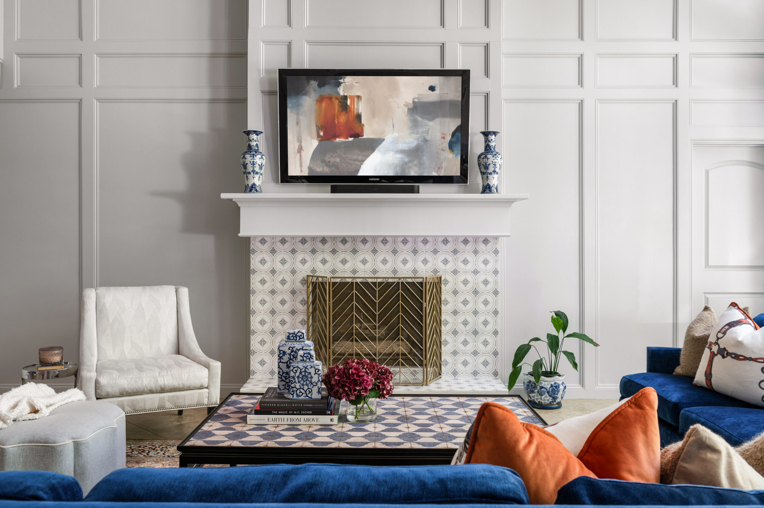 Stunning living room interior design with a fireplace, tv, and a blue velvet couch