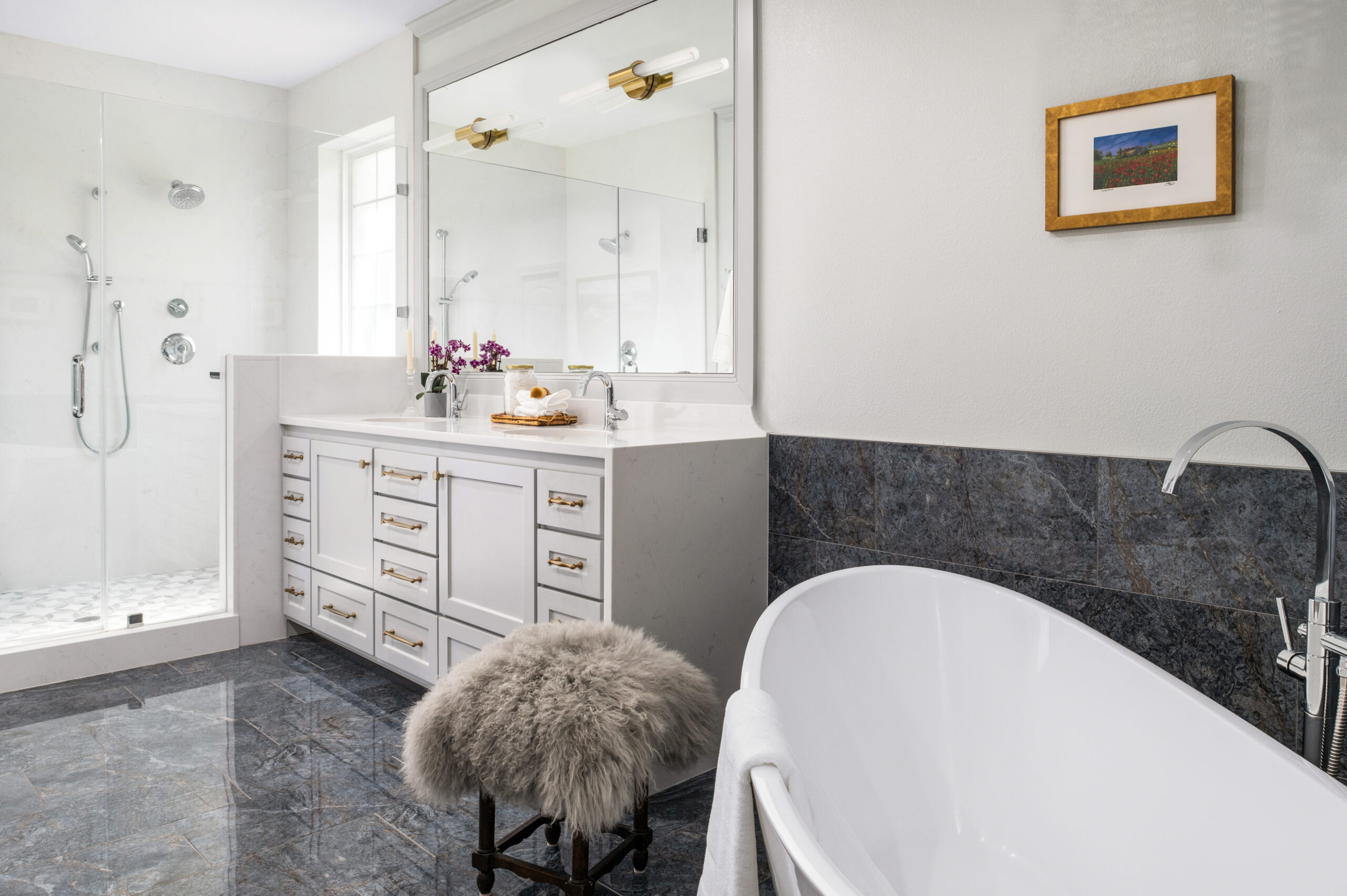 Modern bathroom interior with gray tiled flooring, a big bathtub and shower