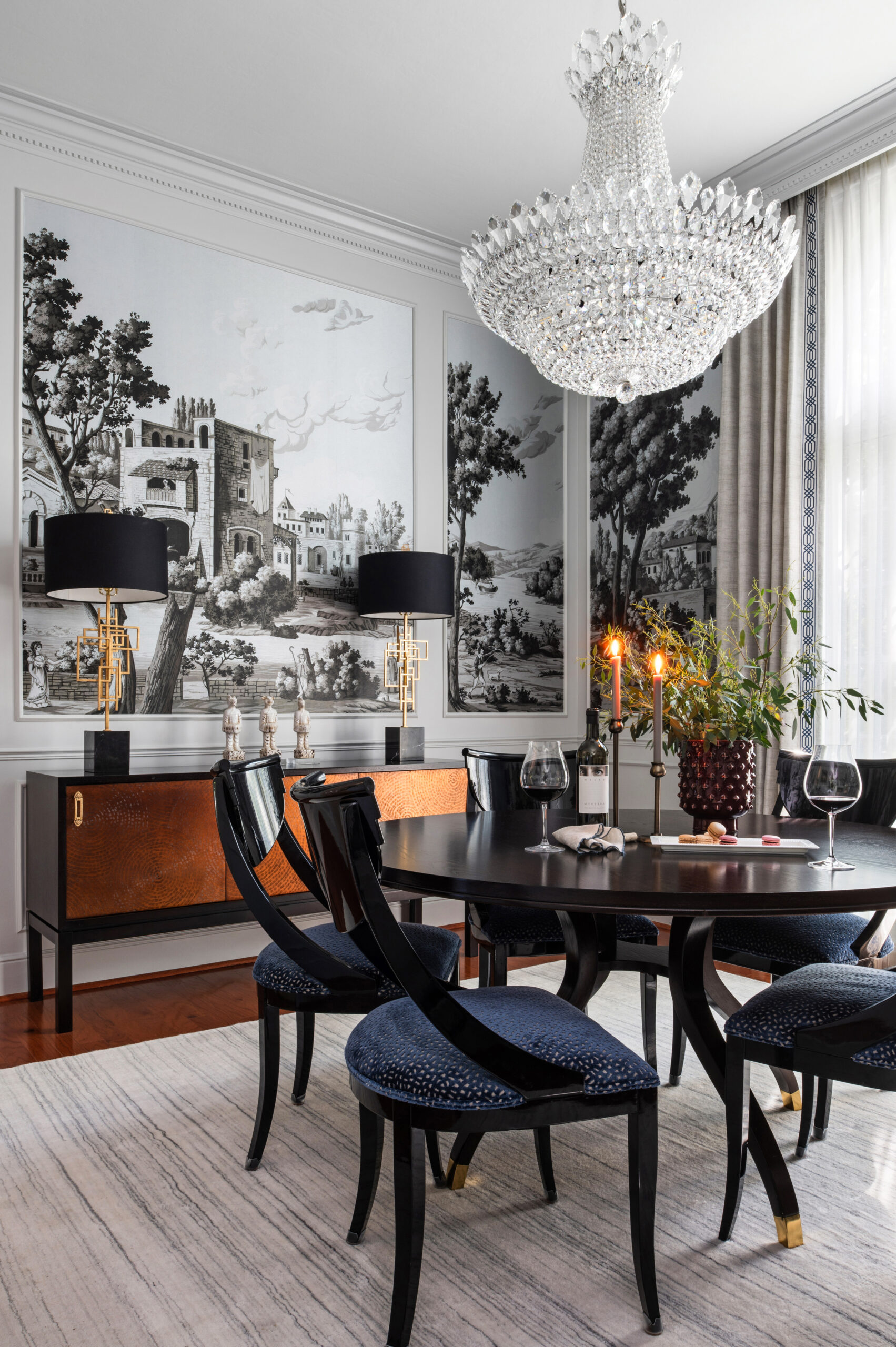 Bold dining room interior design with mural wall and crystal chandelier