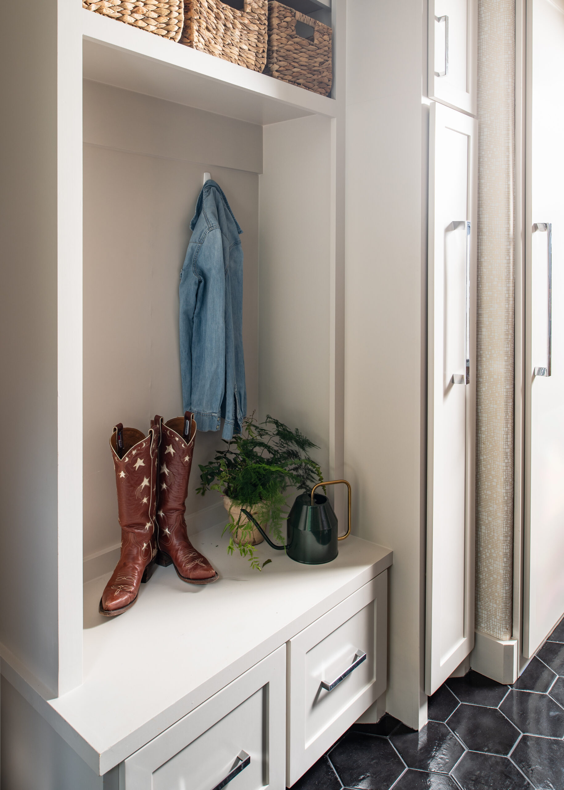 Midcentury modern interior design of home entry way with cowgirl boots and a plant