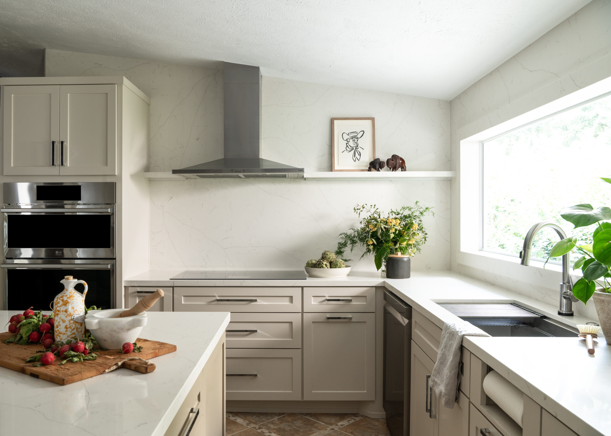 Kitchen Midcentury modern interior design with off white marble counters and cabinets