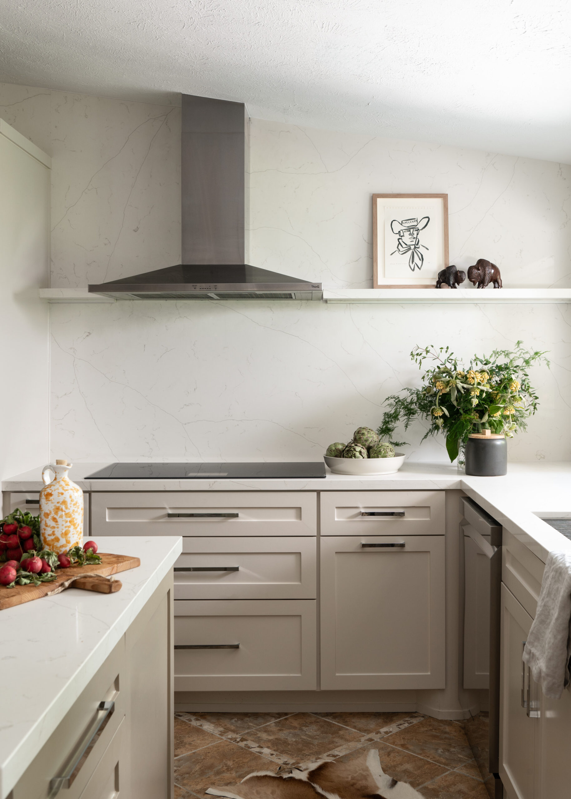 Kitchen Midcentury modern interior design with off white marble counters and cabinets