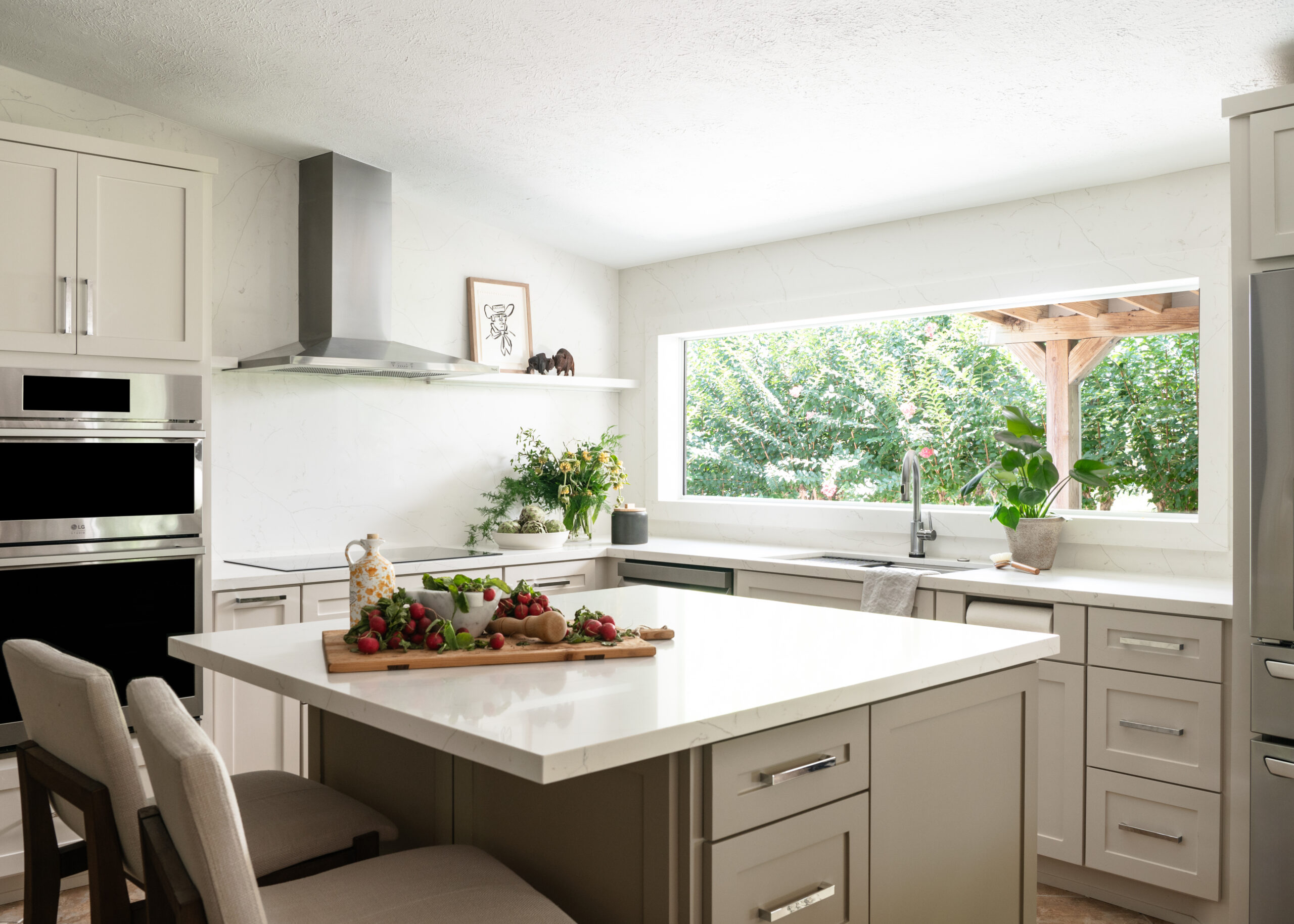 Kitchen Midcentury modern interior design with off white marble counters and cabinets