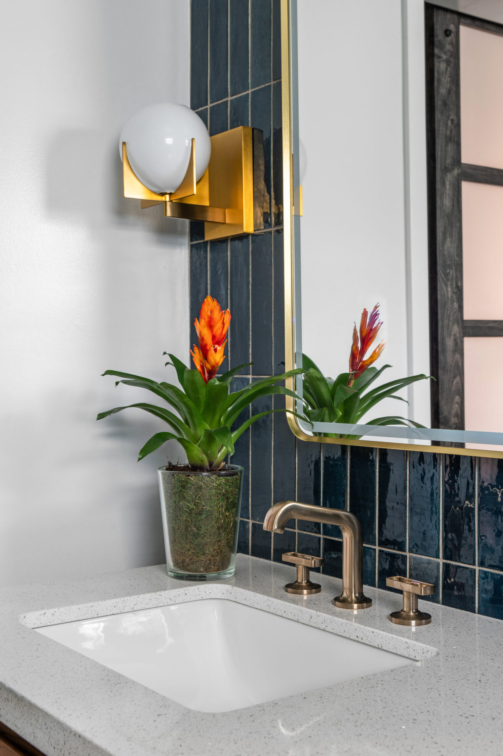 Luxury bathroom interior design with blue tile backsplash and gold accents