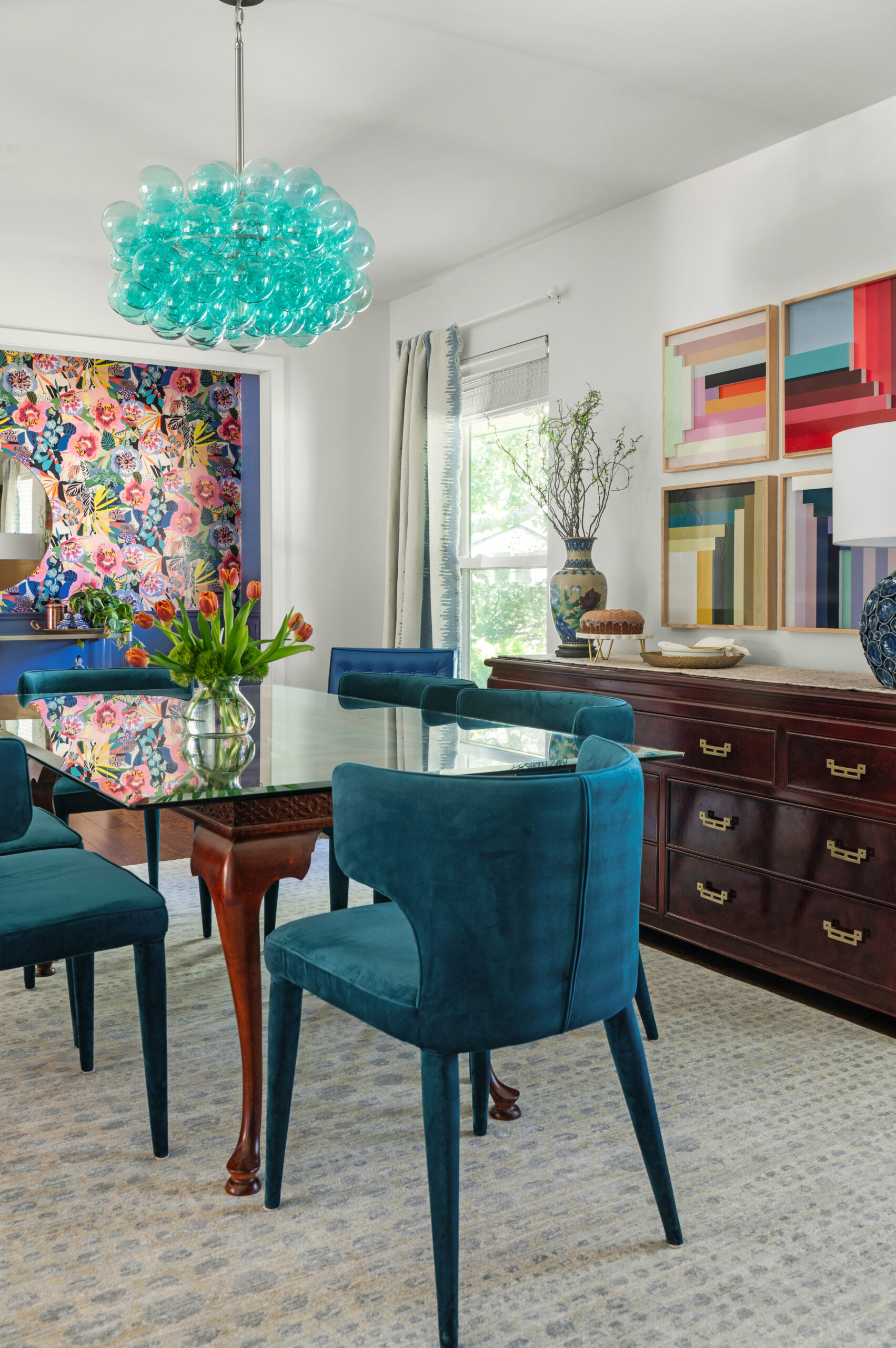 warm and colorful interior design with blue velvet chairs and blue bubble chandelier