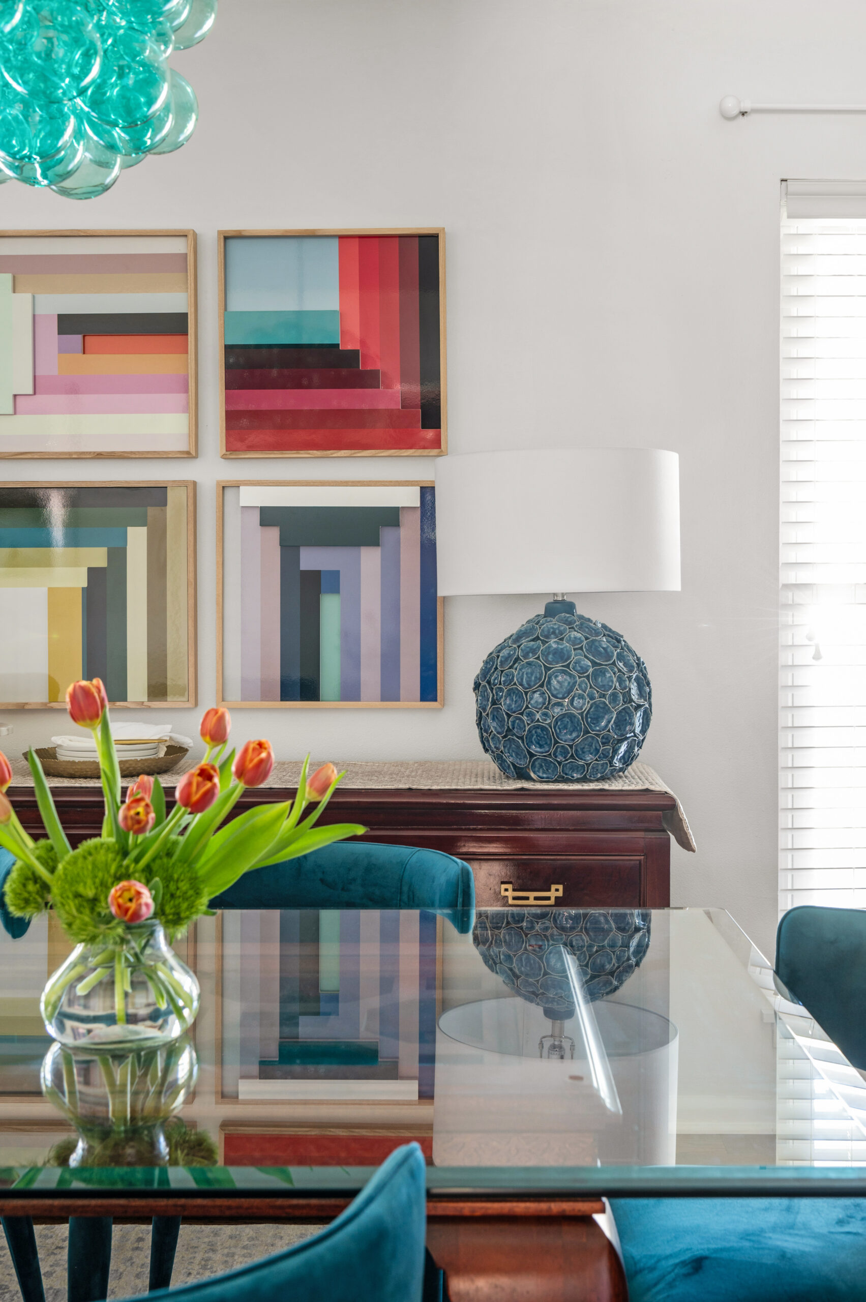 warm and colorful interior design with blue velvet chairs and blue bubble chandelier