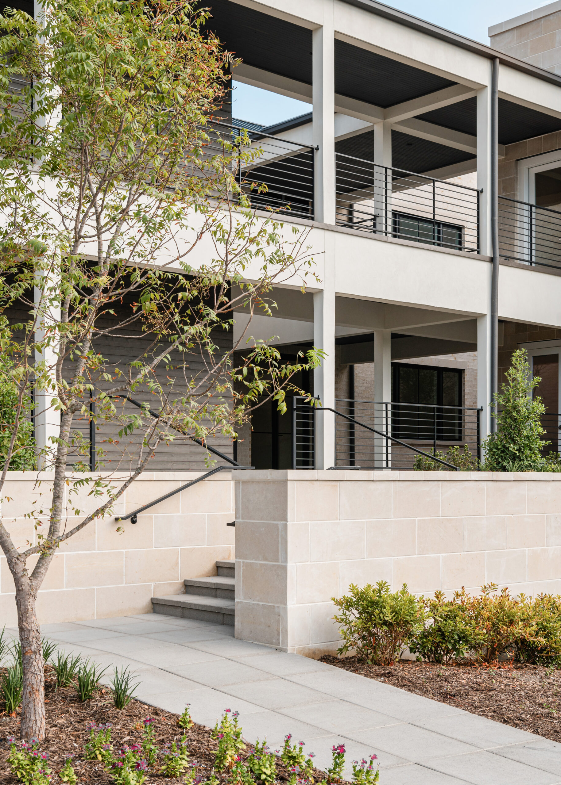 Modern Texas interior design featuring a sleek, contemporary exterior with clean lines, neutral tones, and minimalist landscaping, highlighting the blend of natural elements and modern architecture.