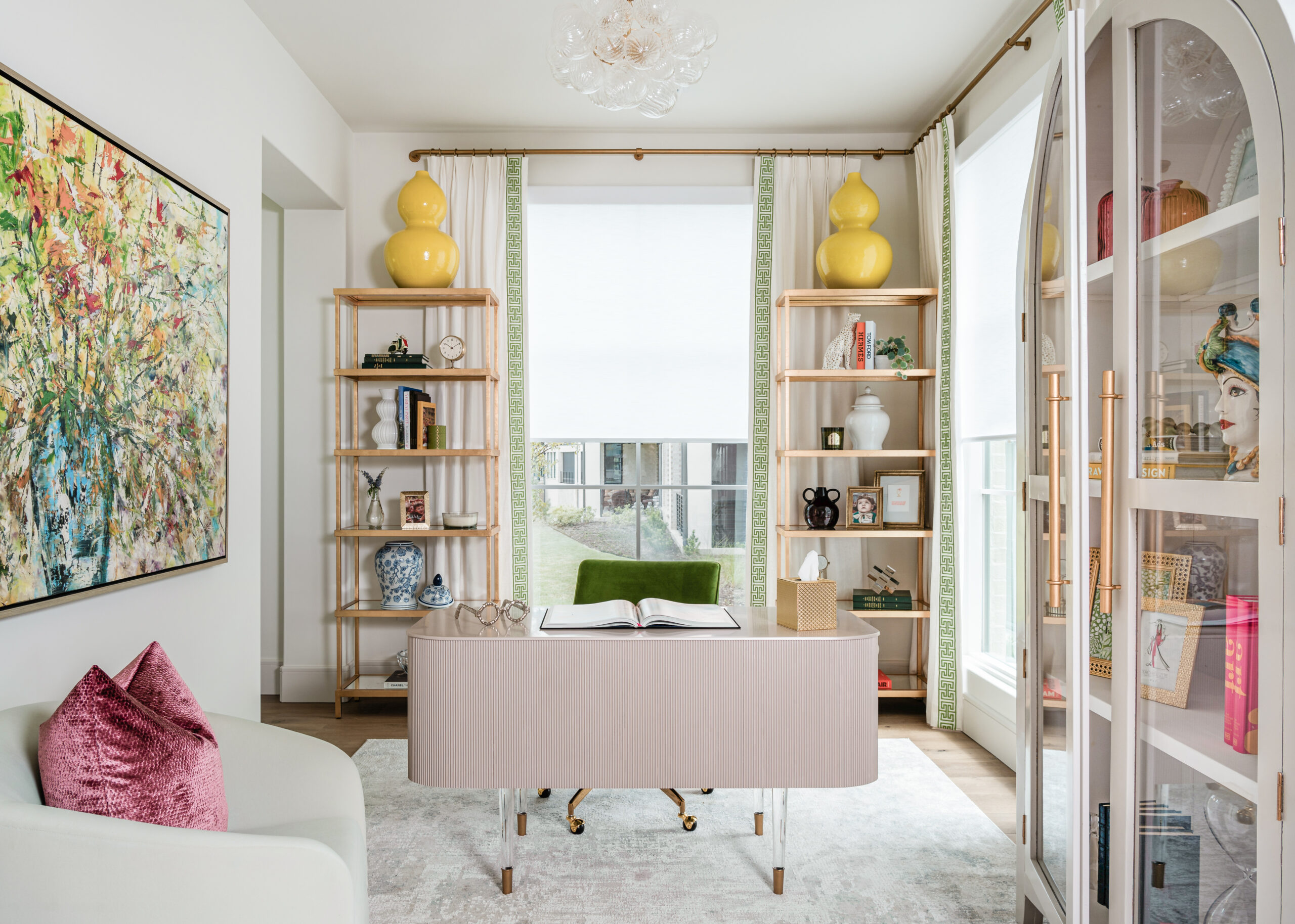 Bright and stylish home office: A modern home office with light-toned furniture, pops of green and yellow, and built-in shelving, featuring bold artwork that ties the room together.