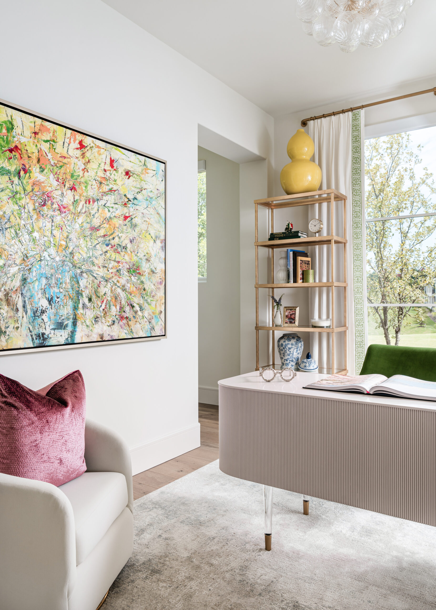 Bright and stylish home office: A modern home office with light-toned furniture, pops of green and yellow, and built-in shelving, featuring bold artwork that ties the room together.