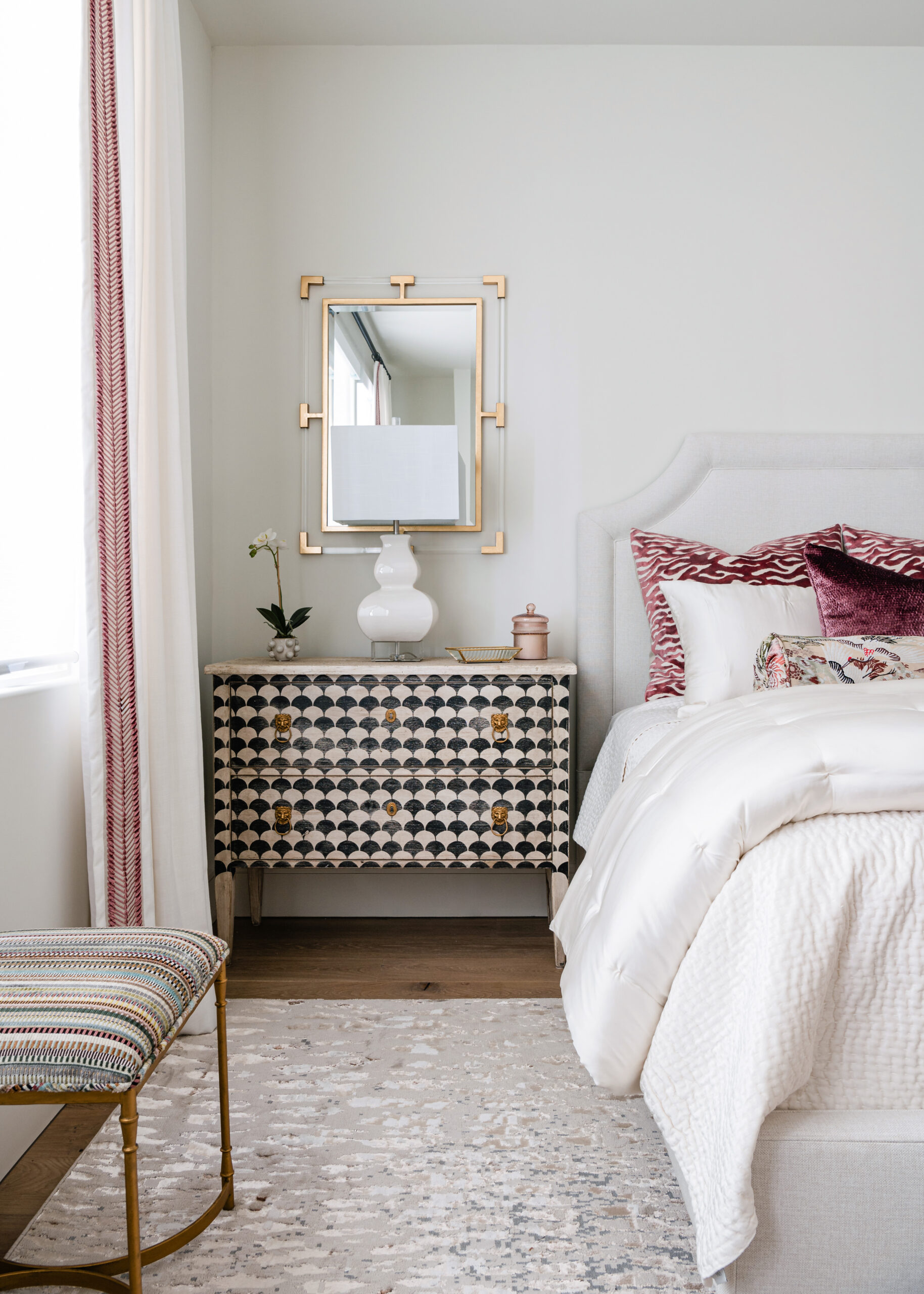 Luxurious bed with textured pillows and headboard: A cozy, modern Texas interior design bedroom with plush bedding, textured throw pillows, and a tufted headboard, all set against a light, airy backdrop.