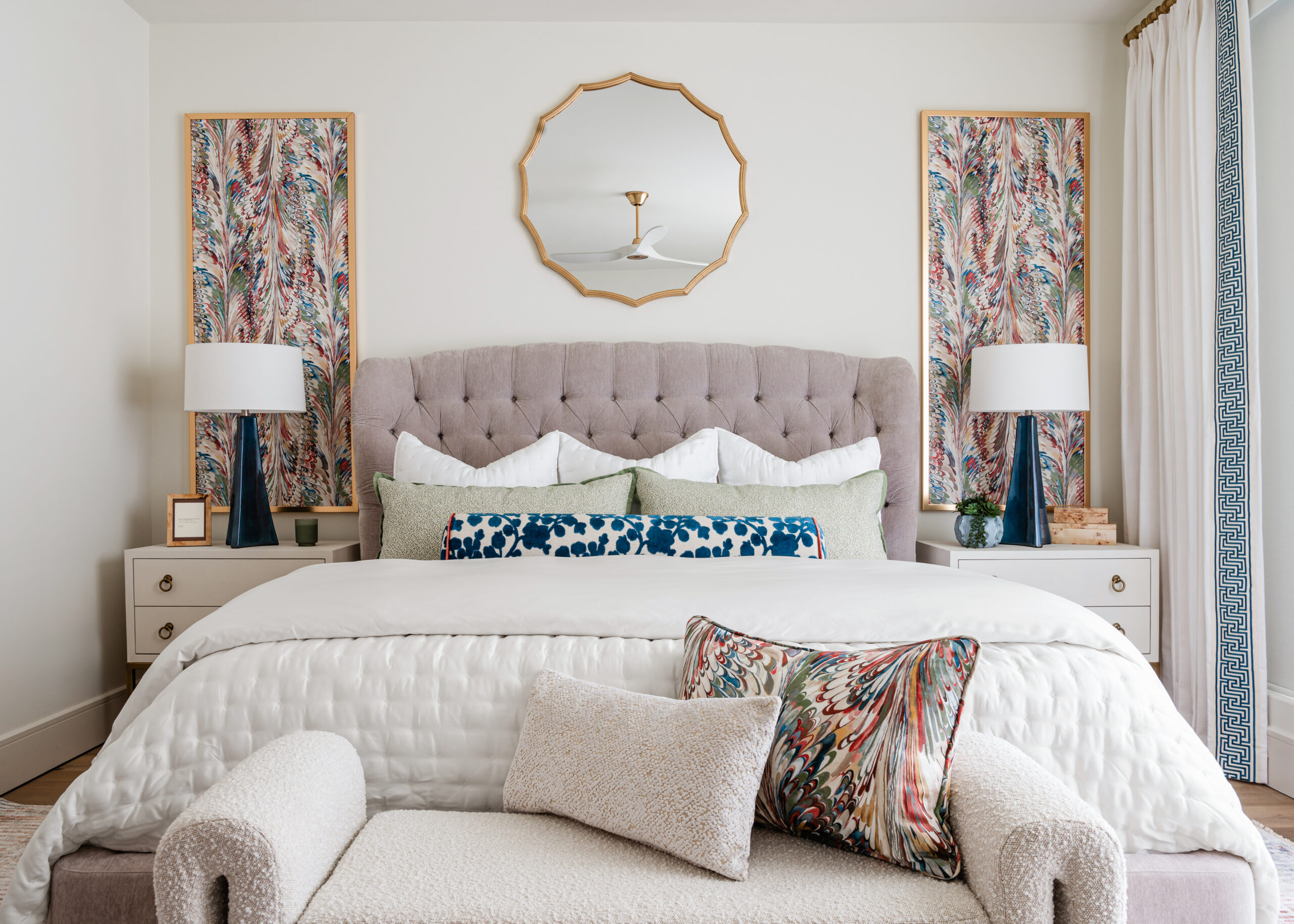 A beautifully designed bedroom featuring a tufted headboard, luxurious bedding, and artistic details, reflecting the sophistication of Texas interior design