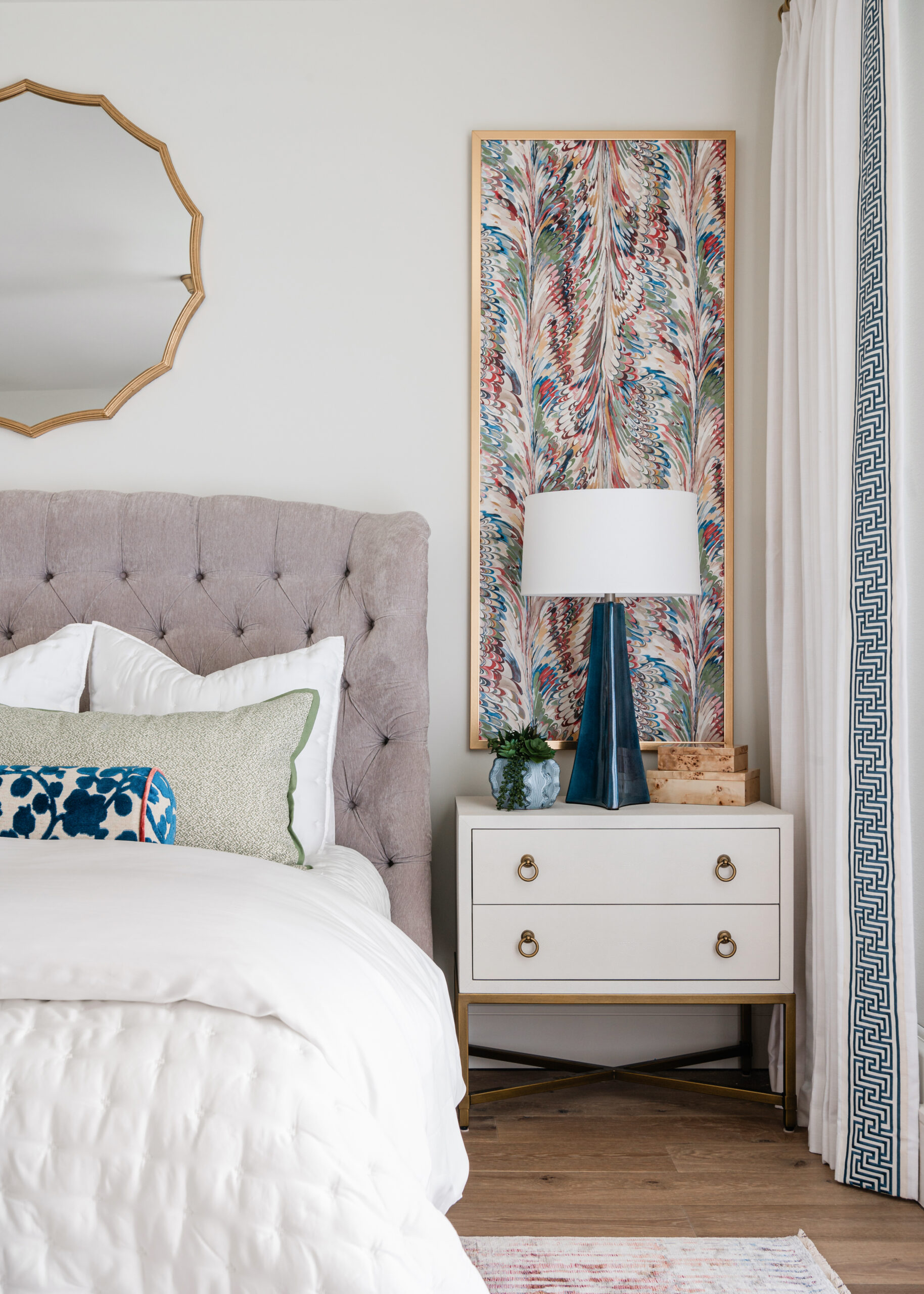 A cozy bedroom with plush textures and patterned pillows, showcasing vibrant textiles and attention to detail characteristic of Texas interior design.