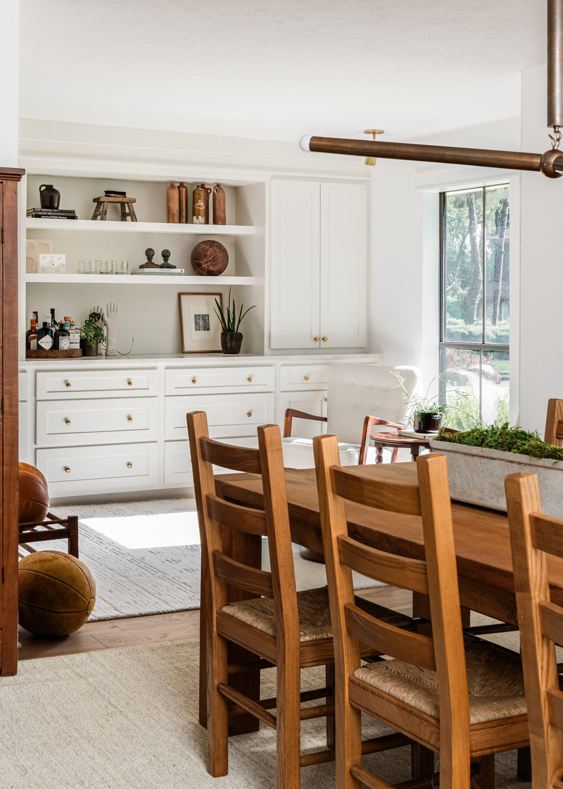 Dining room interior design with wooden dining table facing open living room layout