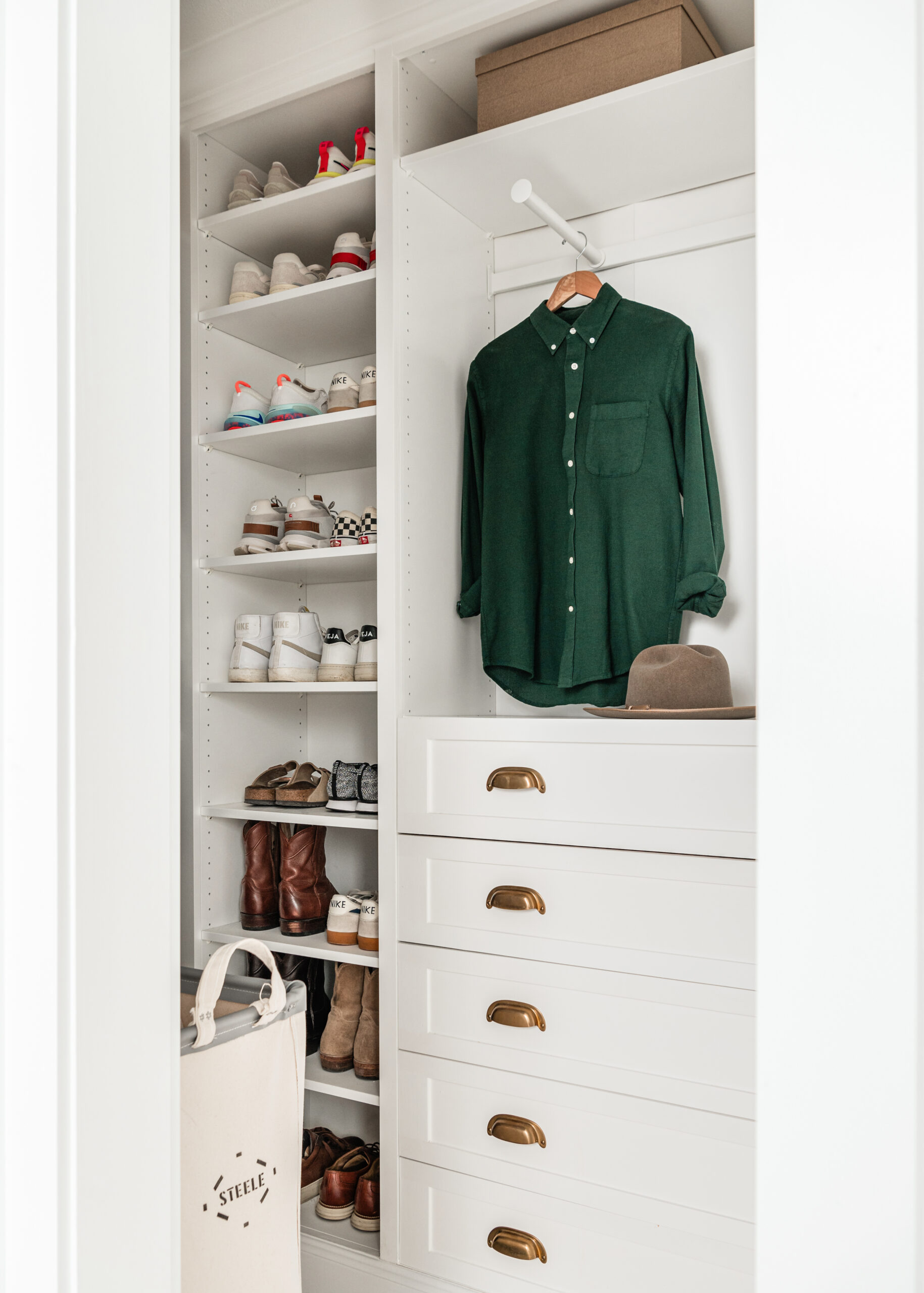 Closet interior design with bright white paint and gold accents