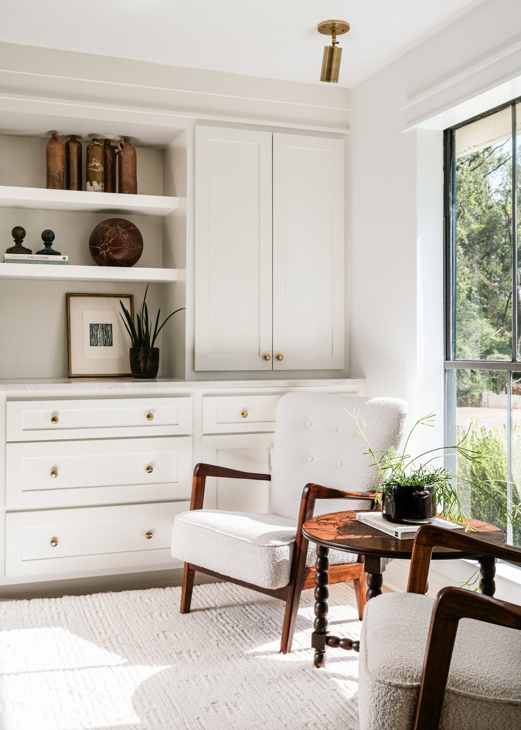 Modern living room interior design with white side chairs and cabinets