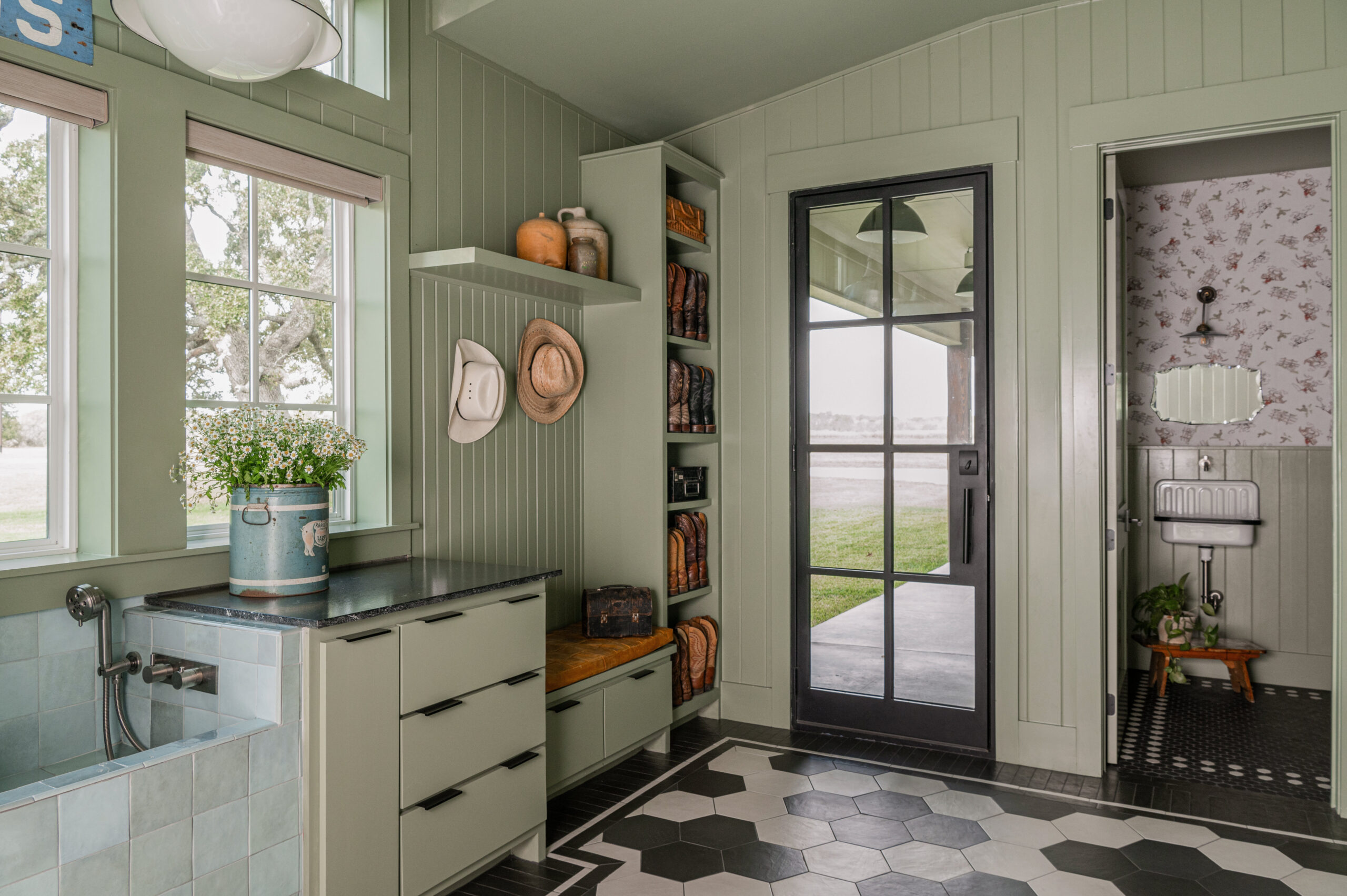 Custom kitchen design with large windows and green cabinetry, showcasing a spacious and inviting atmosphere for a luxurious custom interior design style.