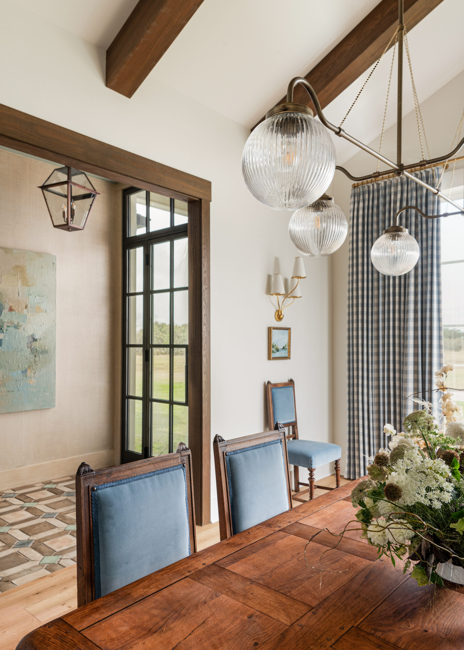 Dining room with custom designed lighting fixtures and elegant decor, showing a blend of contemporary and classic elements for an elevated custom interior design look.