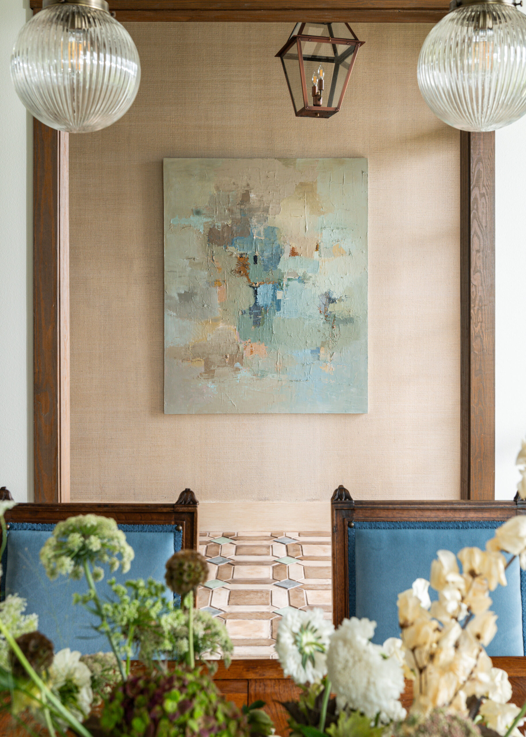 Artistic wall decor featuring a modern abstract piece, enhancing the custom interior design of this dining room with high-end finishes and thoughtful design.