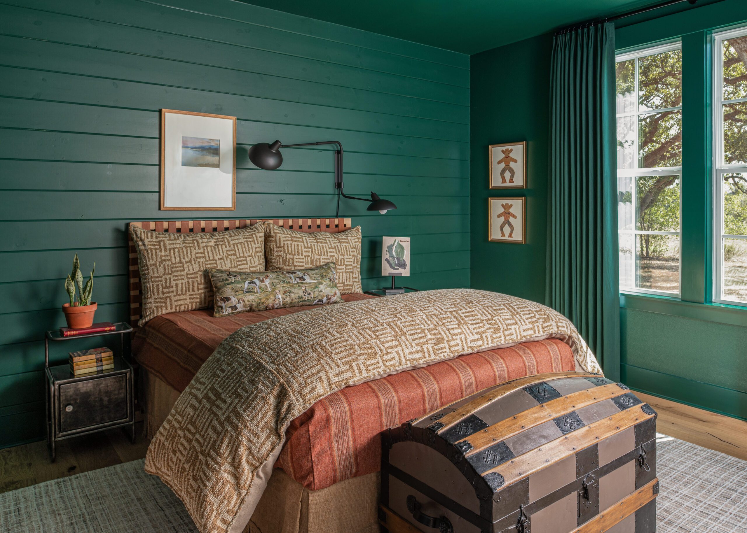 Cozy bedroom with vibrant green walls and thoughtfully designed custom interior design elements that bring warmth and personality to the space.