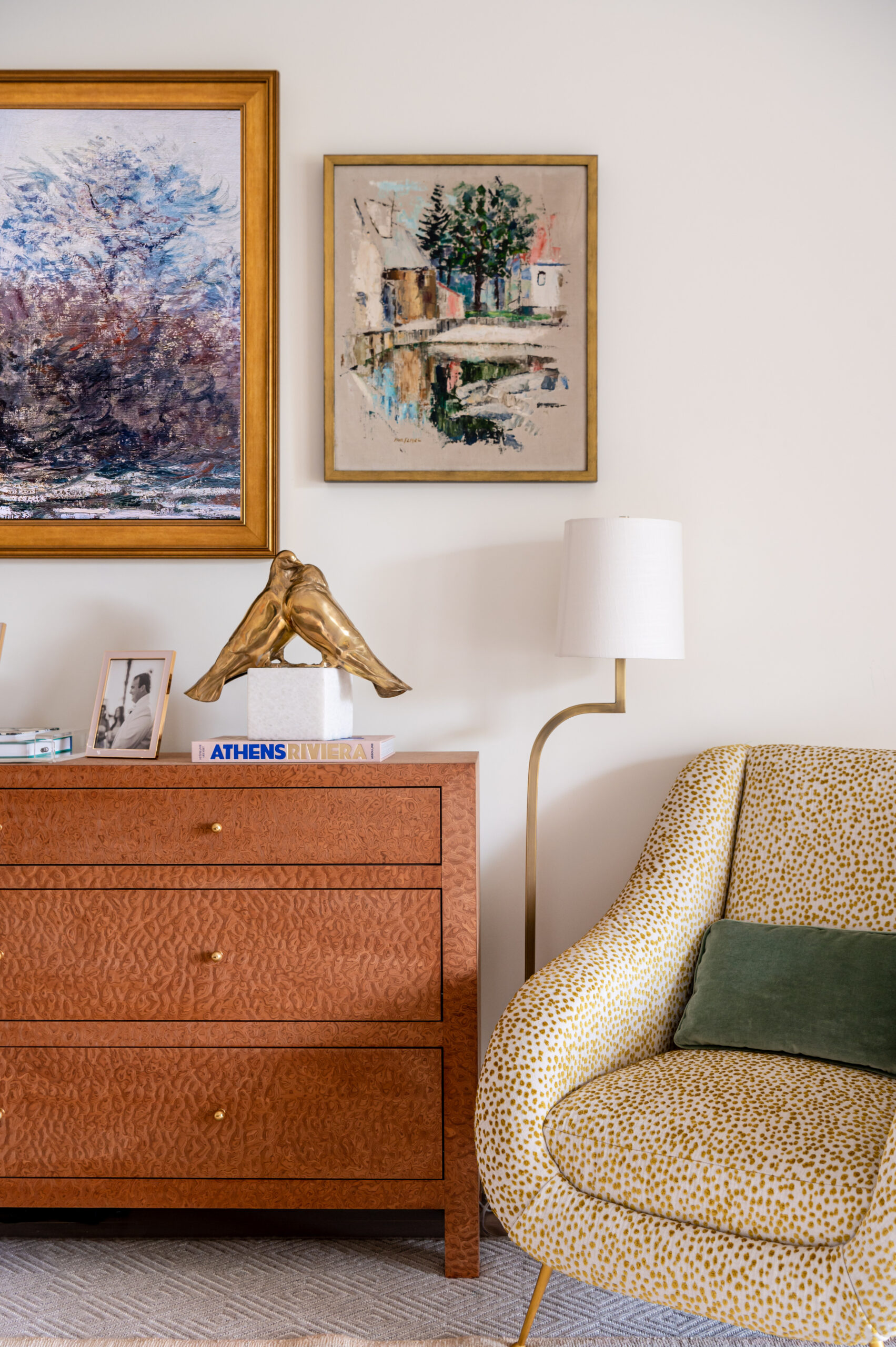 A cozy living space with a mix of vintage and contemporary art. The armchair's unique pattern and the decorative sculpture exude a refined yet relaxed aesthetic, showcasing master interior design techniques for an inviting atmosphere.