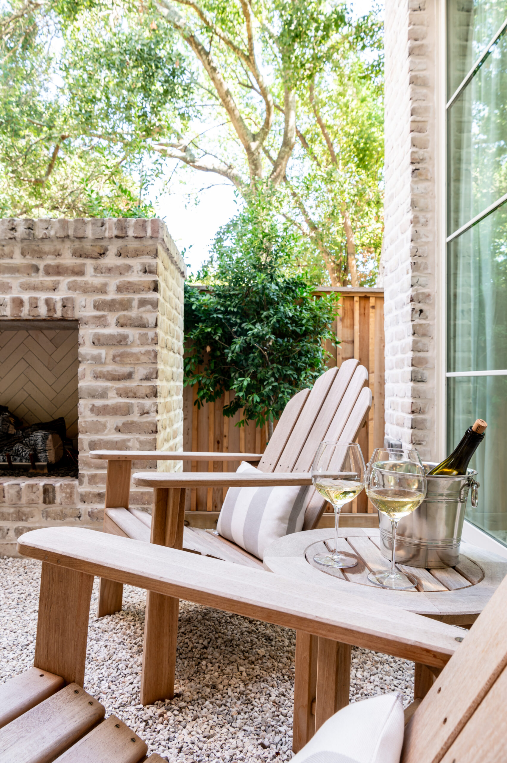 A cozy outdoor seating area by a stone fireplace, perfect for intimate moments, blending natural elements with comfort, embodying master interior design in creating inviting outdoor living spaces.