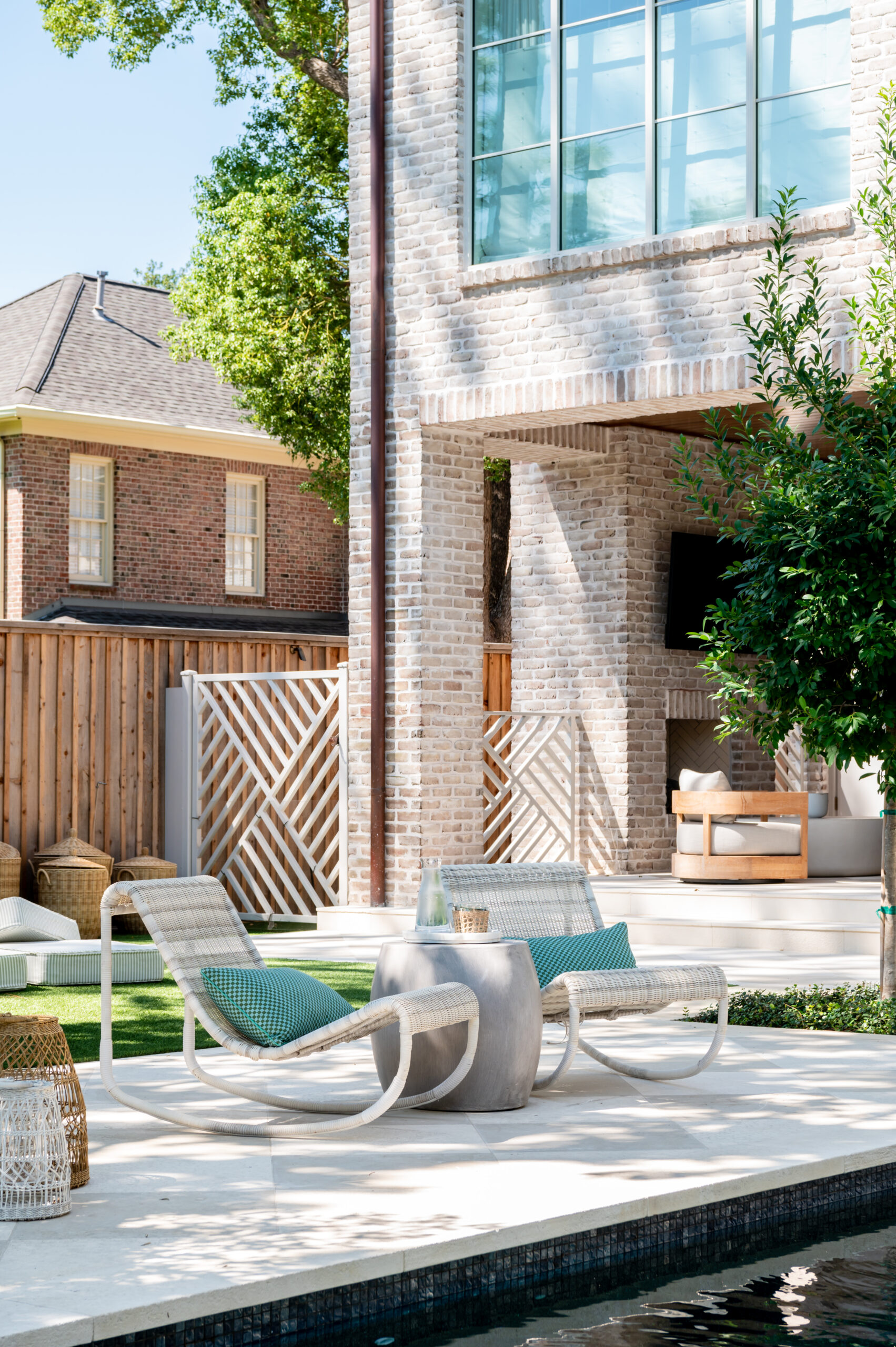 A beautifully designed outdoor patio area with a poolside lounge set featuring modern, comfortable seating and stylish outdoor decor, showcasing the elegance of master interior design in outdoor living spaces.