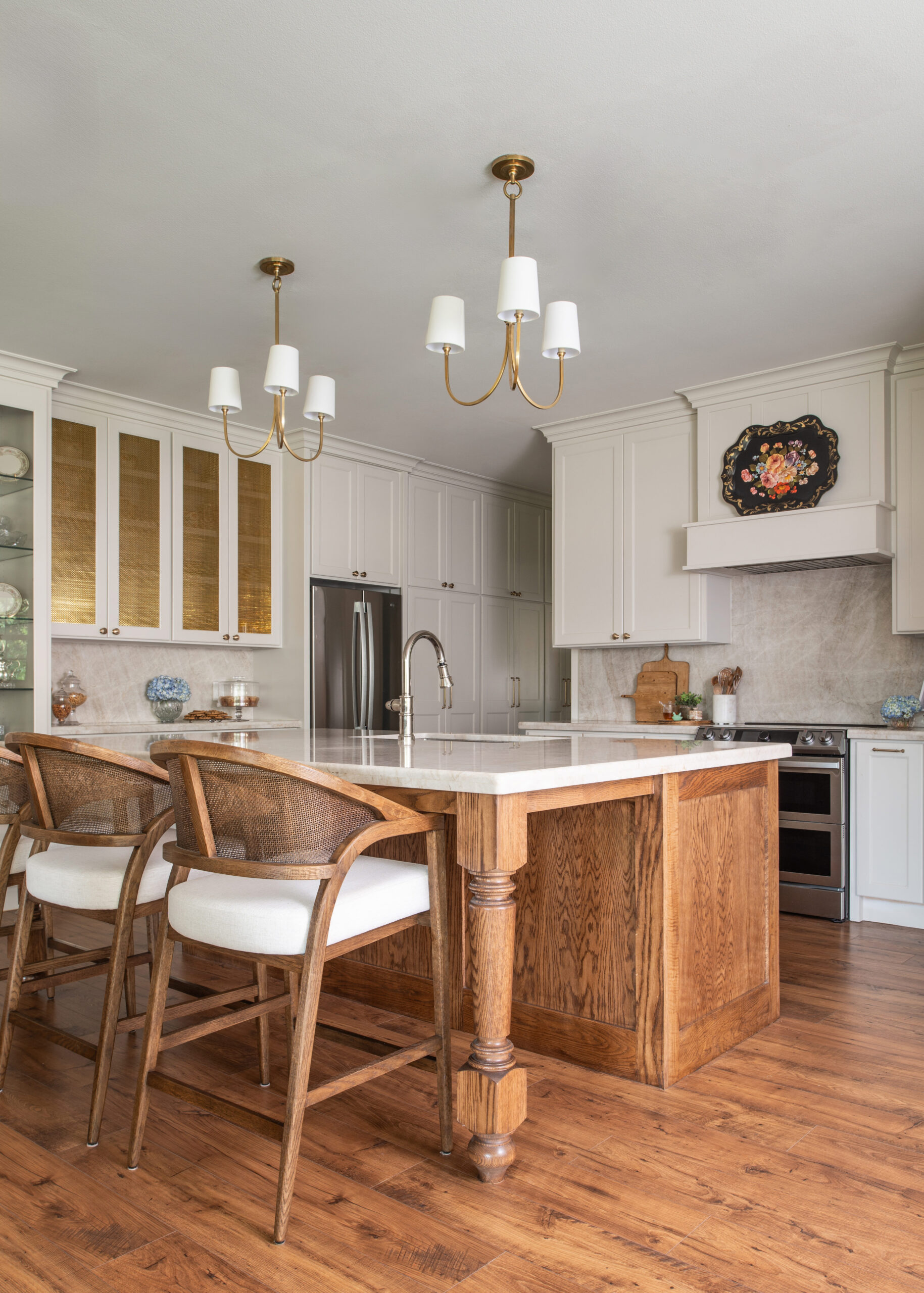 A spacious kitchen featuring a beautifully designed marble countertop and glass cabinets, exuding a timeless modern interior design style with an elegant touch.