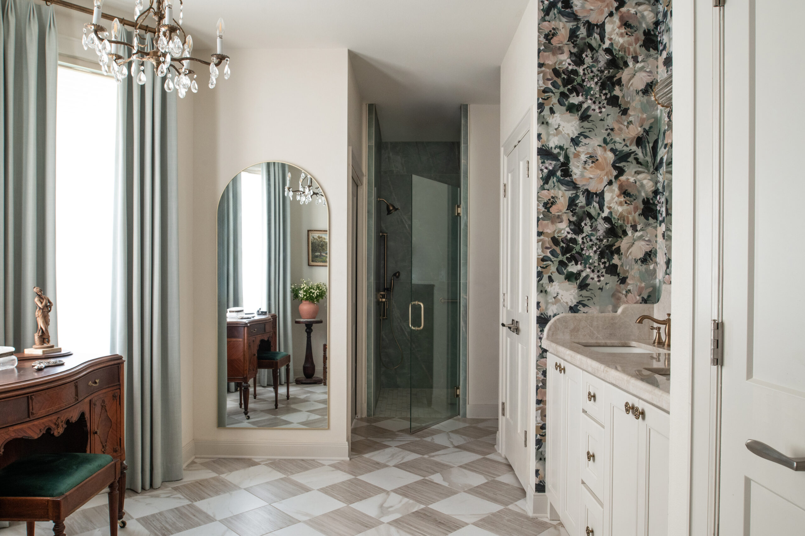 A modern bathroom with floral wallpaper, a spacious mirror, and a clean shower space, beautifully blending timeless modern interior design elements with luxurious finishes.