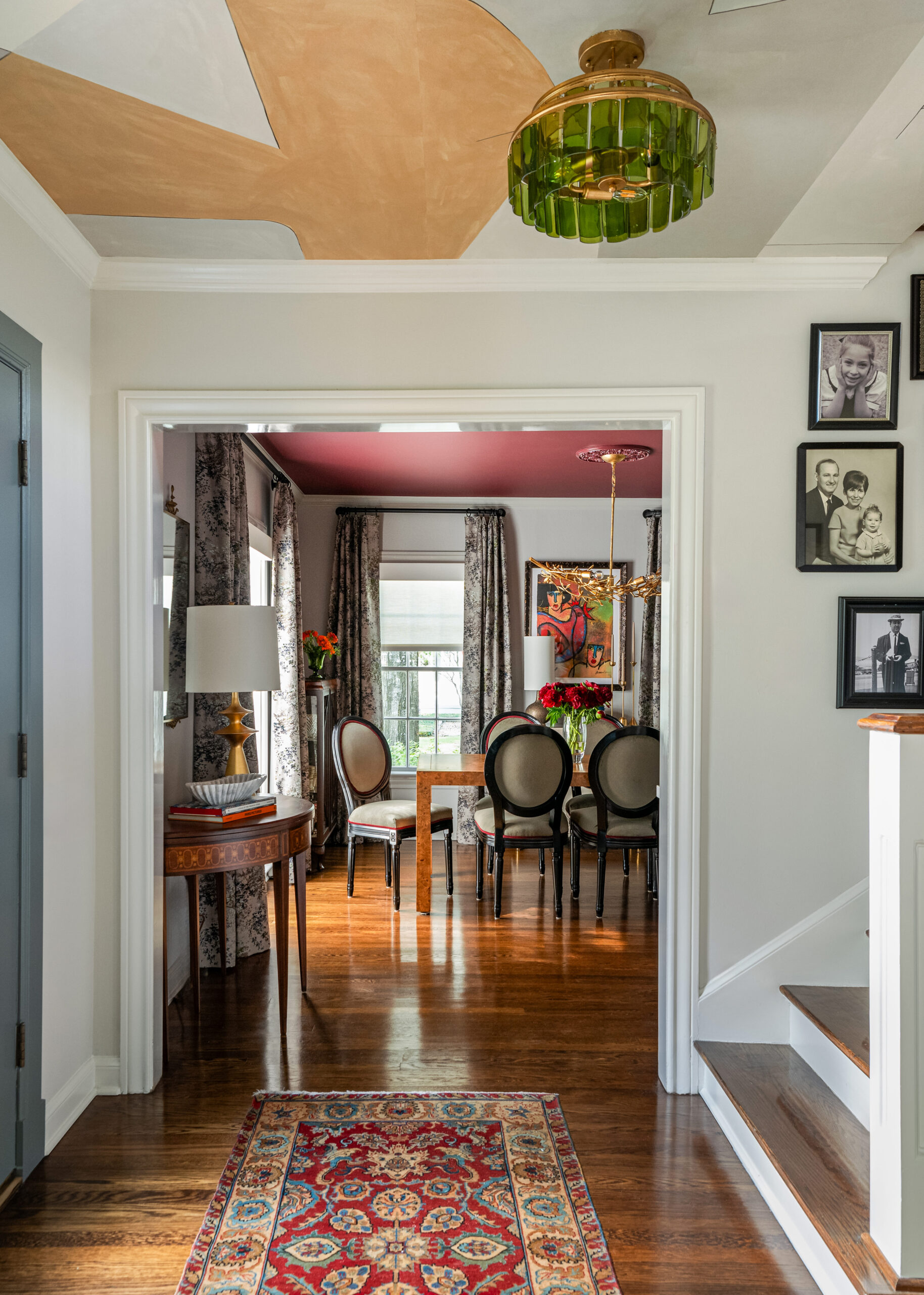 A glimpse of the dining room through a framed doorway. Rich colors and textures in this interior design capture the space’s unique style.