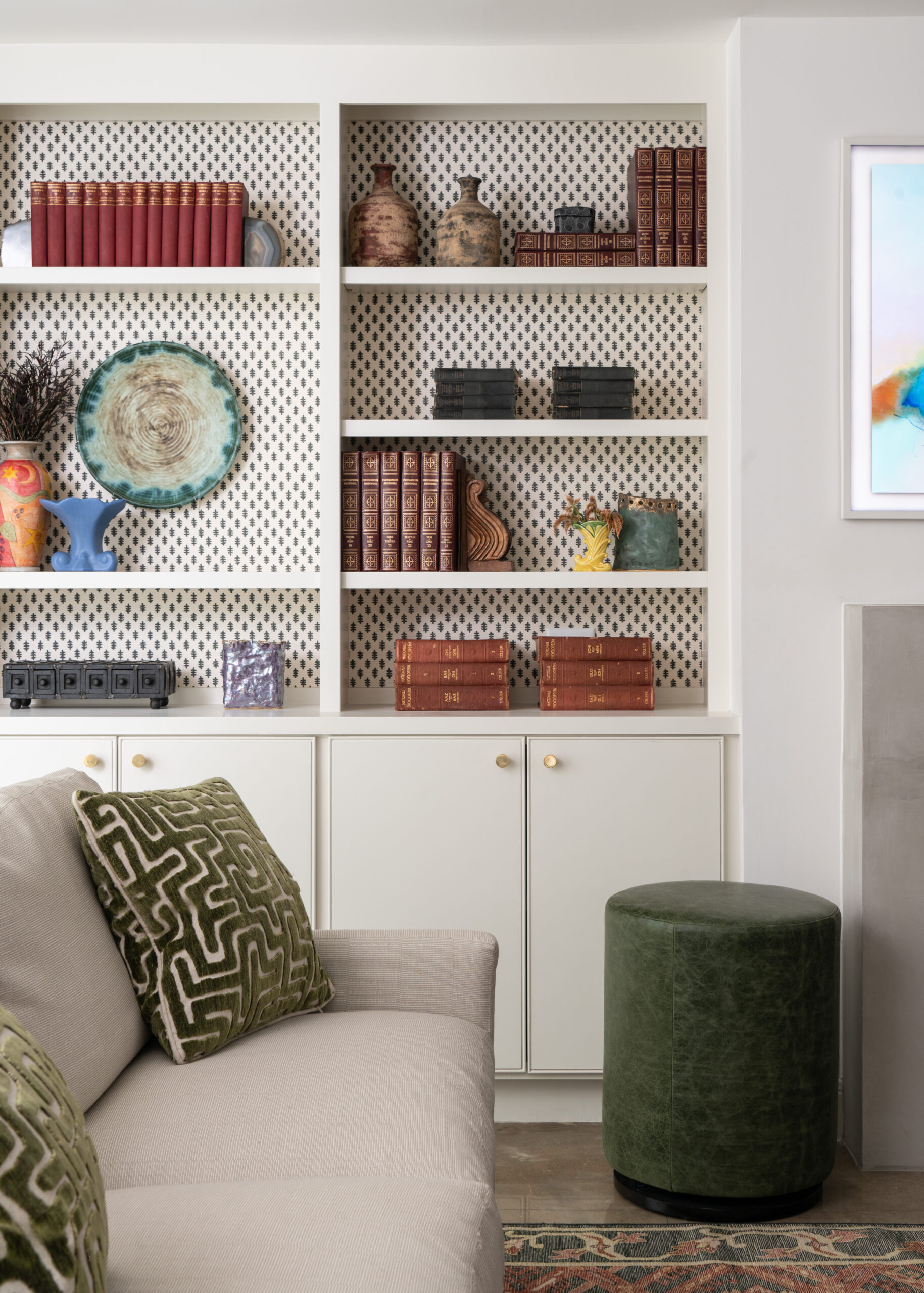 Interior design and photography highlight traditional design elements in a stylish living room with bookshelves and accents.