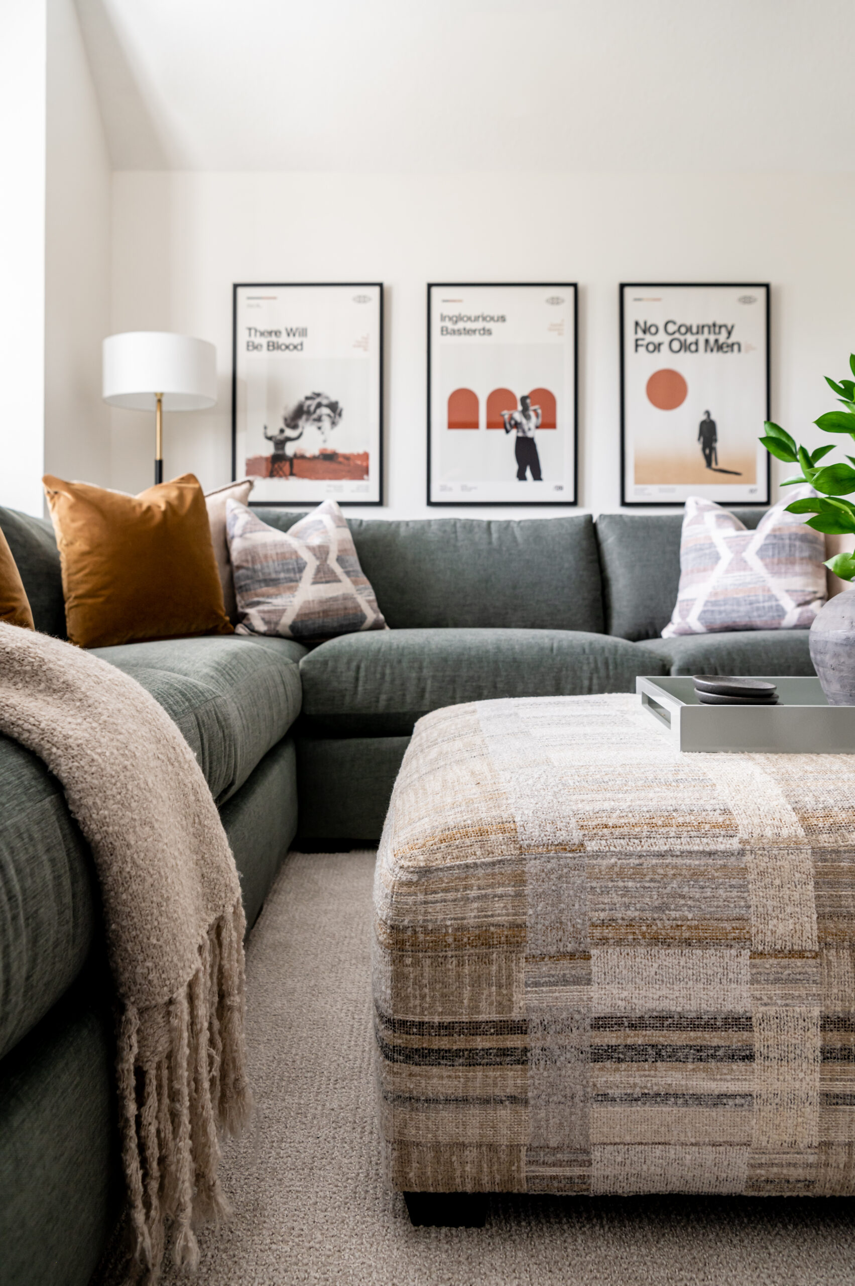 A calming bedroom with neutral tones featuring a beige bed with pillows, wooden nightstands, and a striking black-and-white bison photograph.