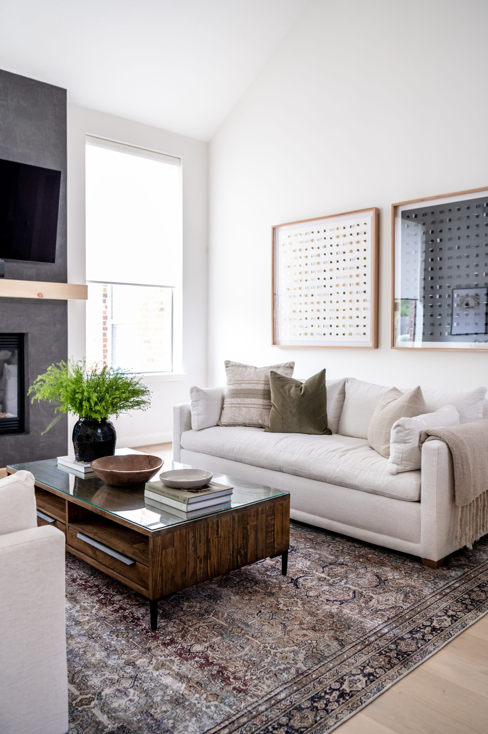 A stylish and inviting living room featuring neutral tones, cozy sofas, and chic wall art