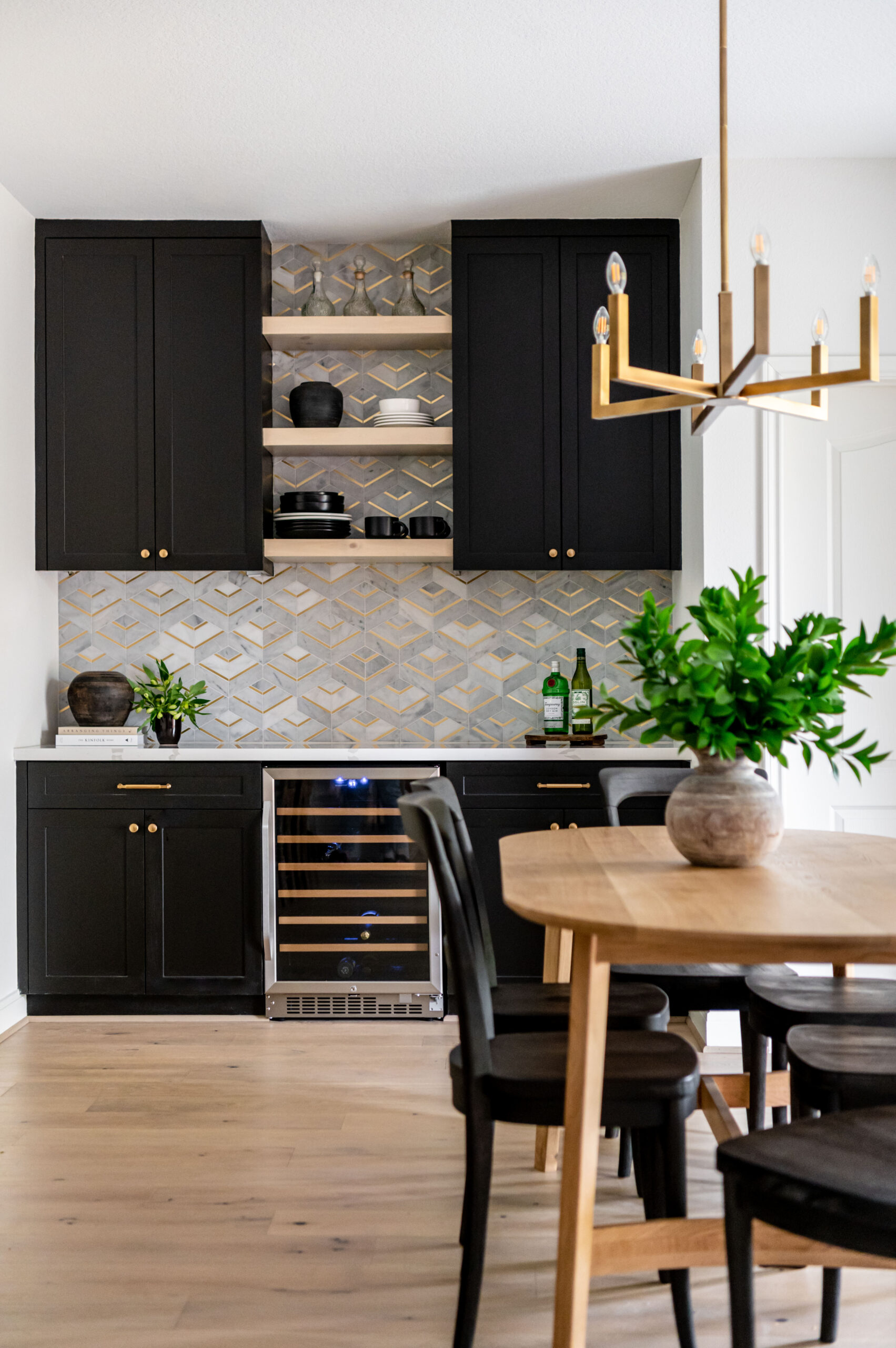 A bright, airy living room with a fireplace and custom shelving. The space is decorated with plants and soft blue tones