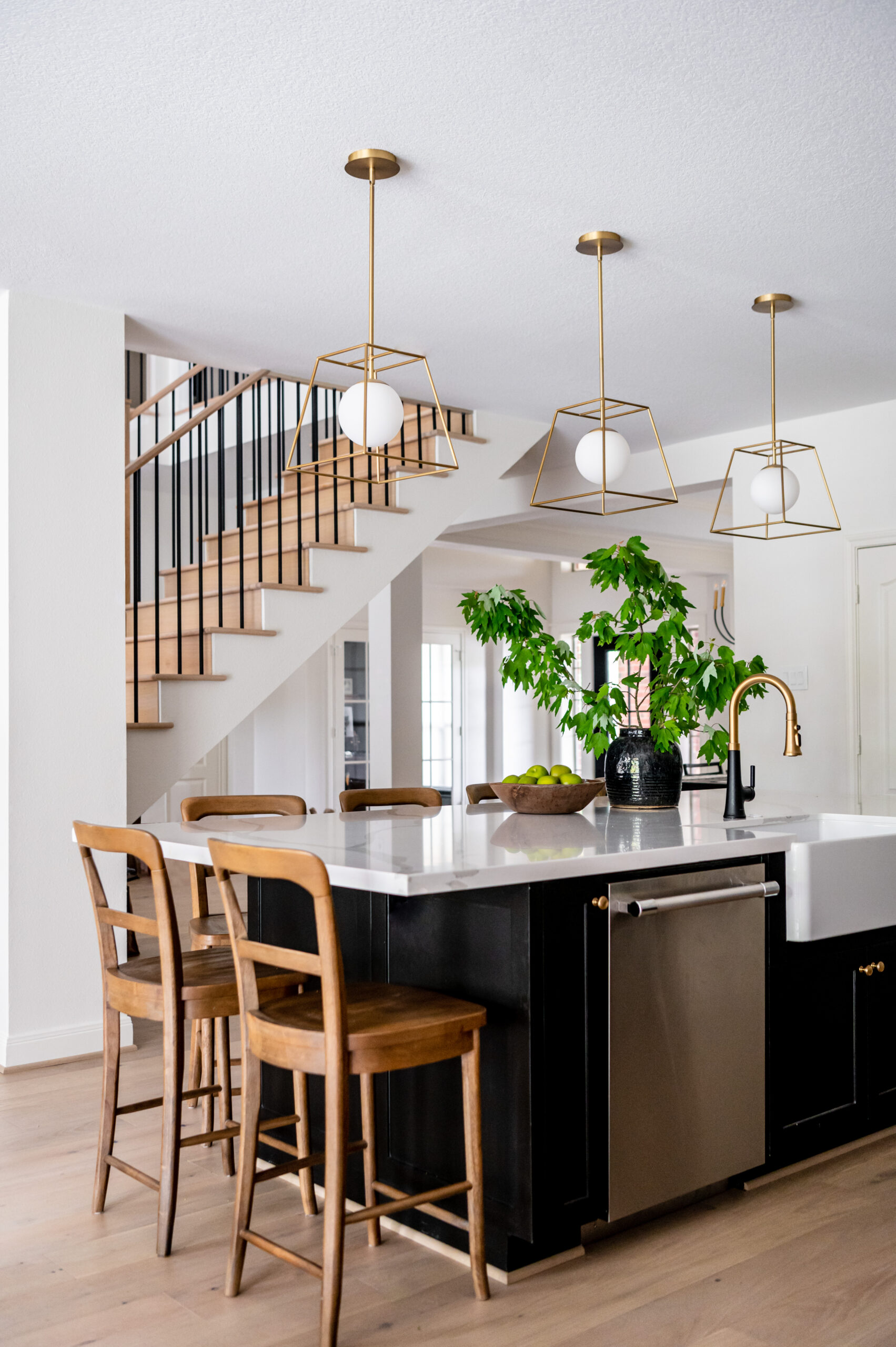 A well-lit dining room with elegant chairs, a chandelier, and a modern, light-filled kitchen backdrop. This space offers a blend of classic and contemporary design for interior design publications.

