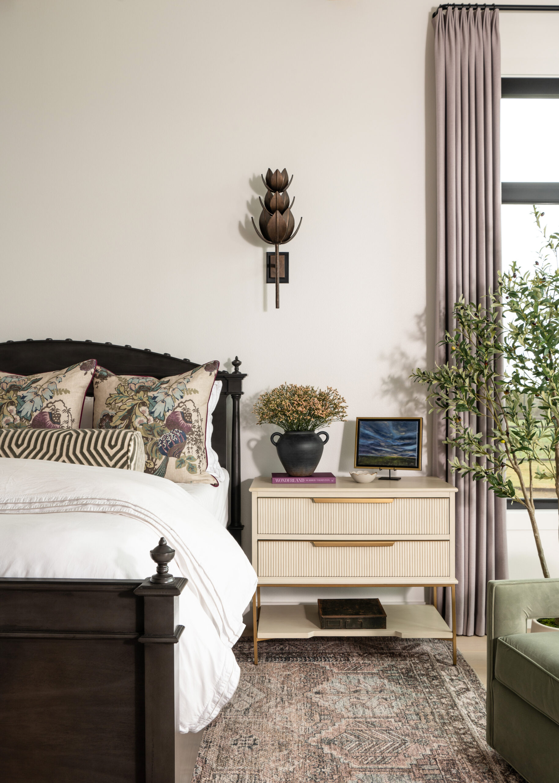 Elegant and modern bedroom with a simple yet sophisticated nightstand and decorative elements, complemented by large windows and natural light