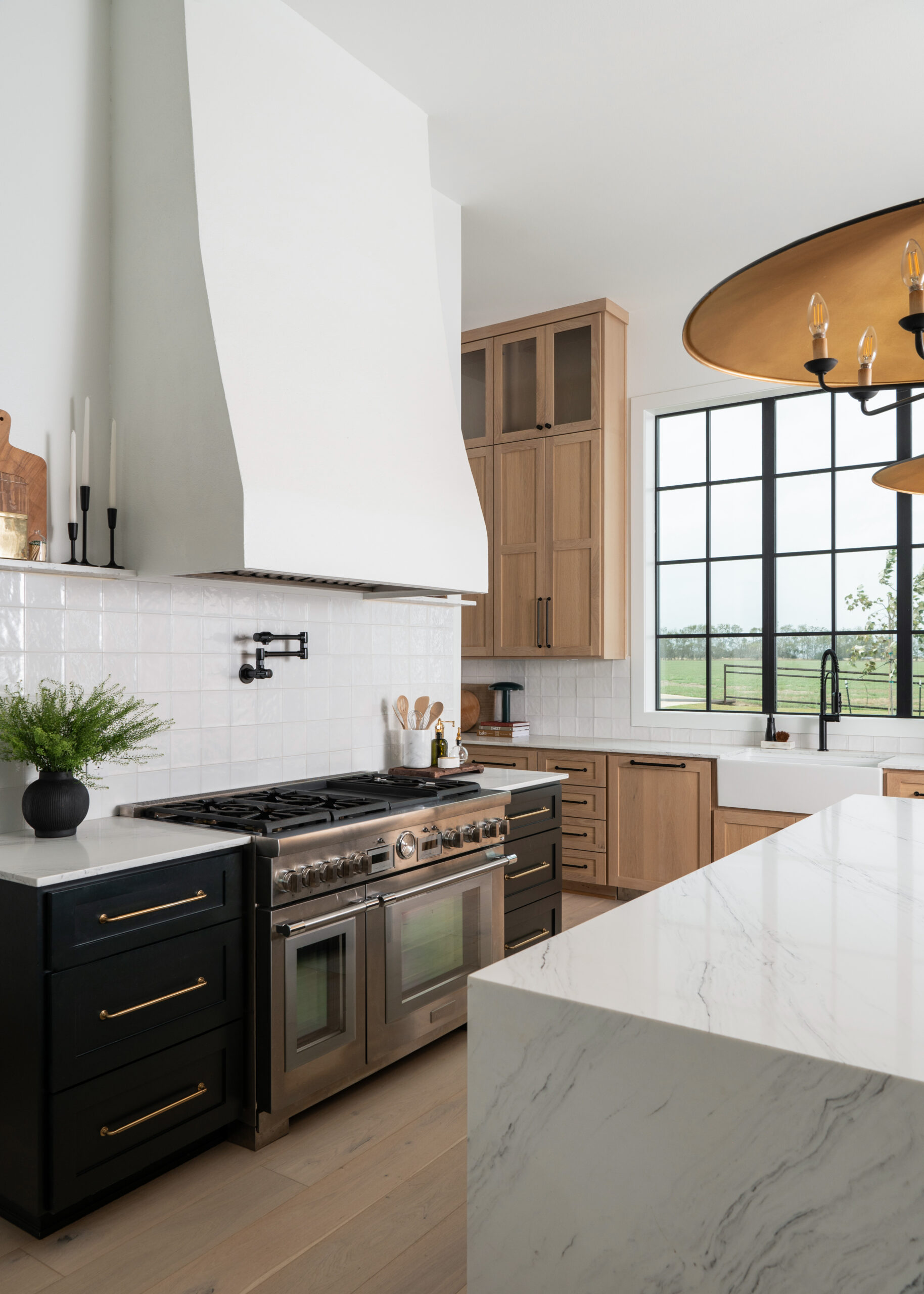 A detailed shot of a modern kitchen's sleek cabinetry and high-end appliances, with natural light flowing in through large windows.