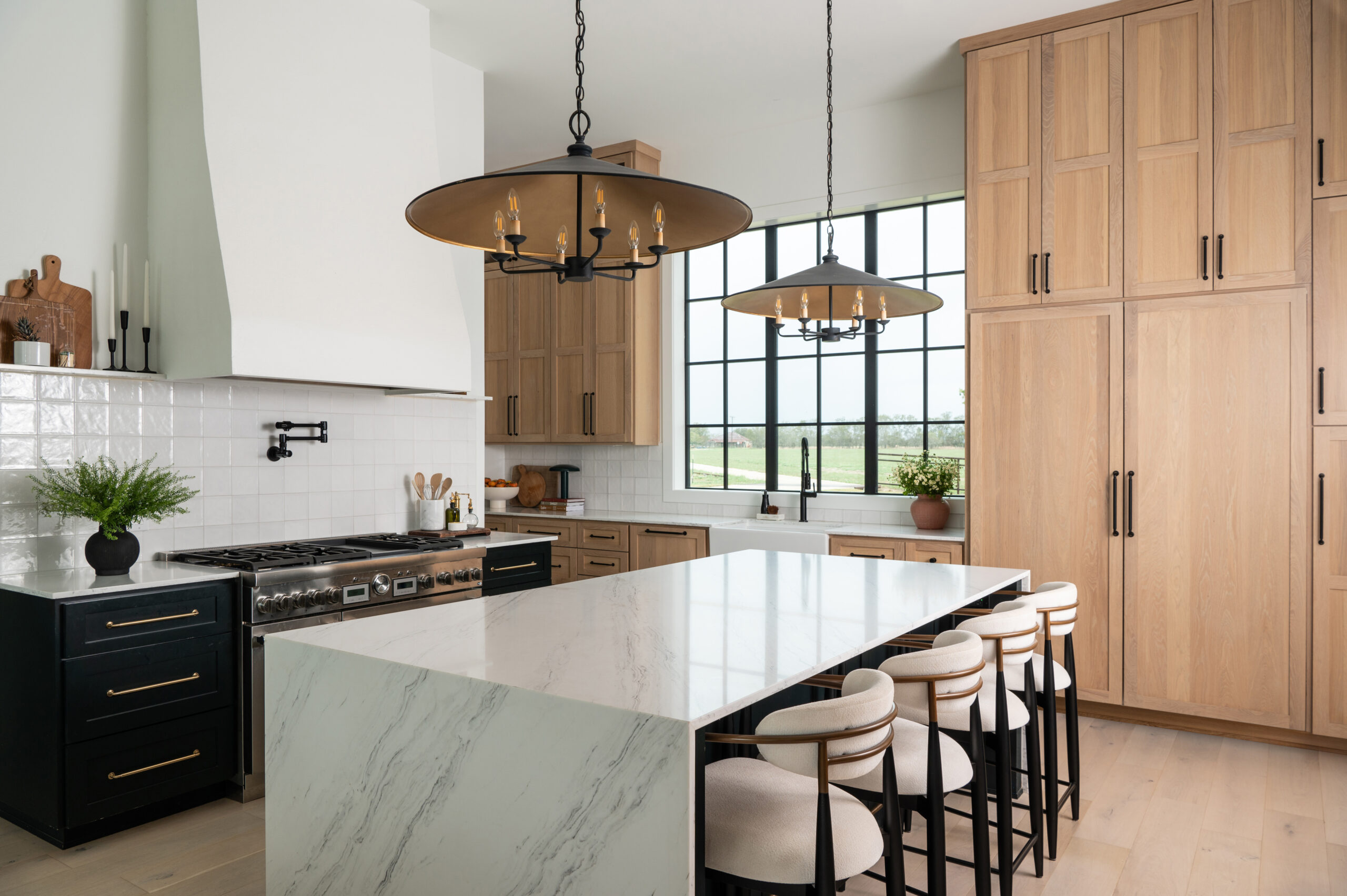 A contemporary kitchen space with a clean and streamlined design, featuring a marble island and minimalist cabinetry.