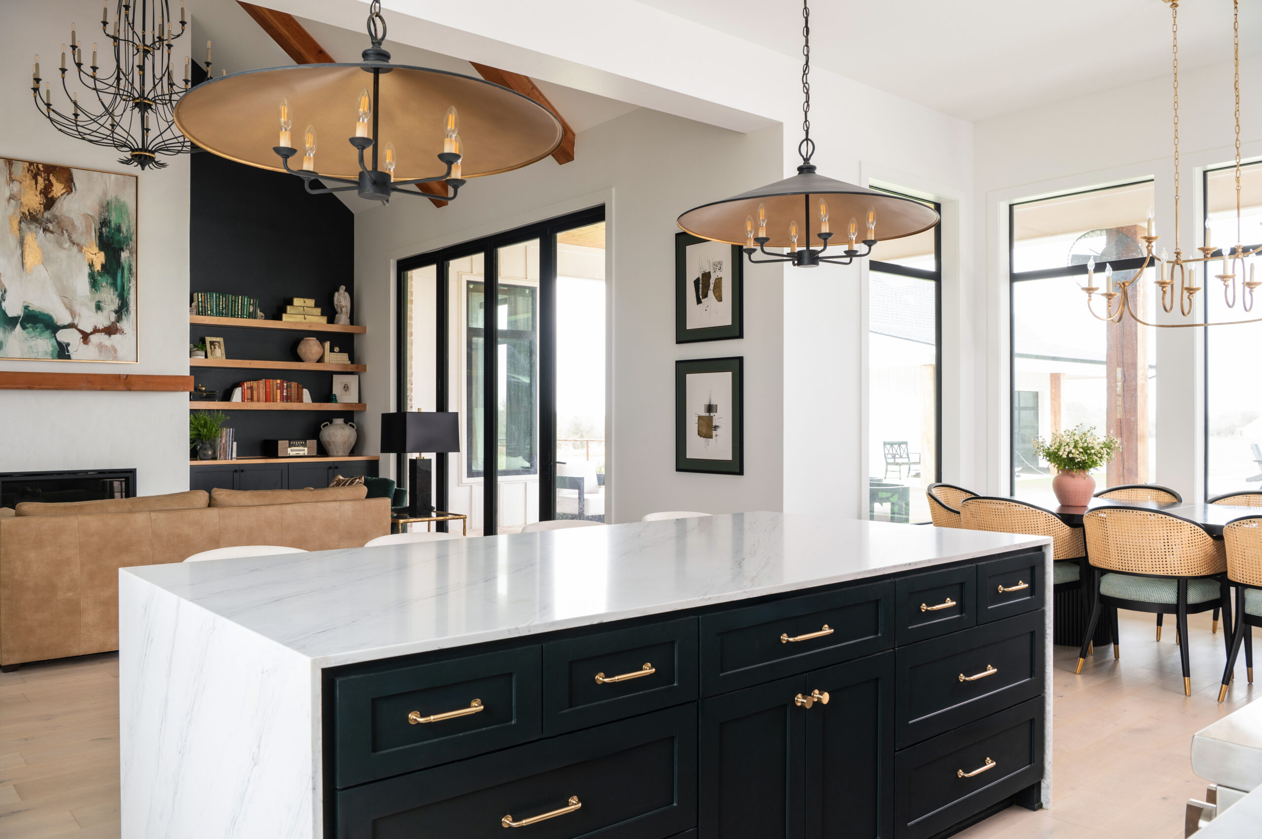 A contemporary kitchen space with a clean and streamlined design, featuring a marble island and minimalist cabinetry.