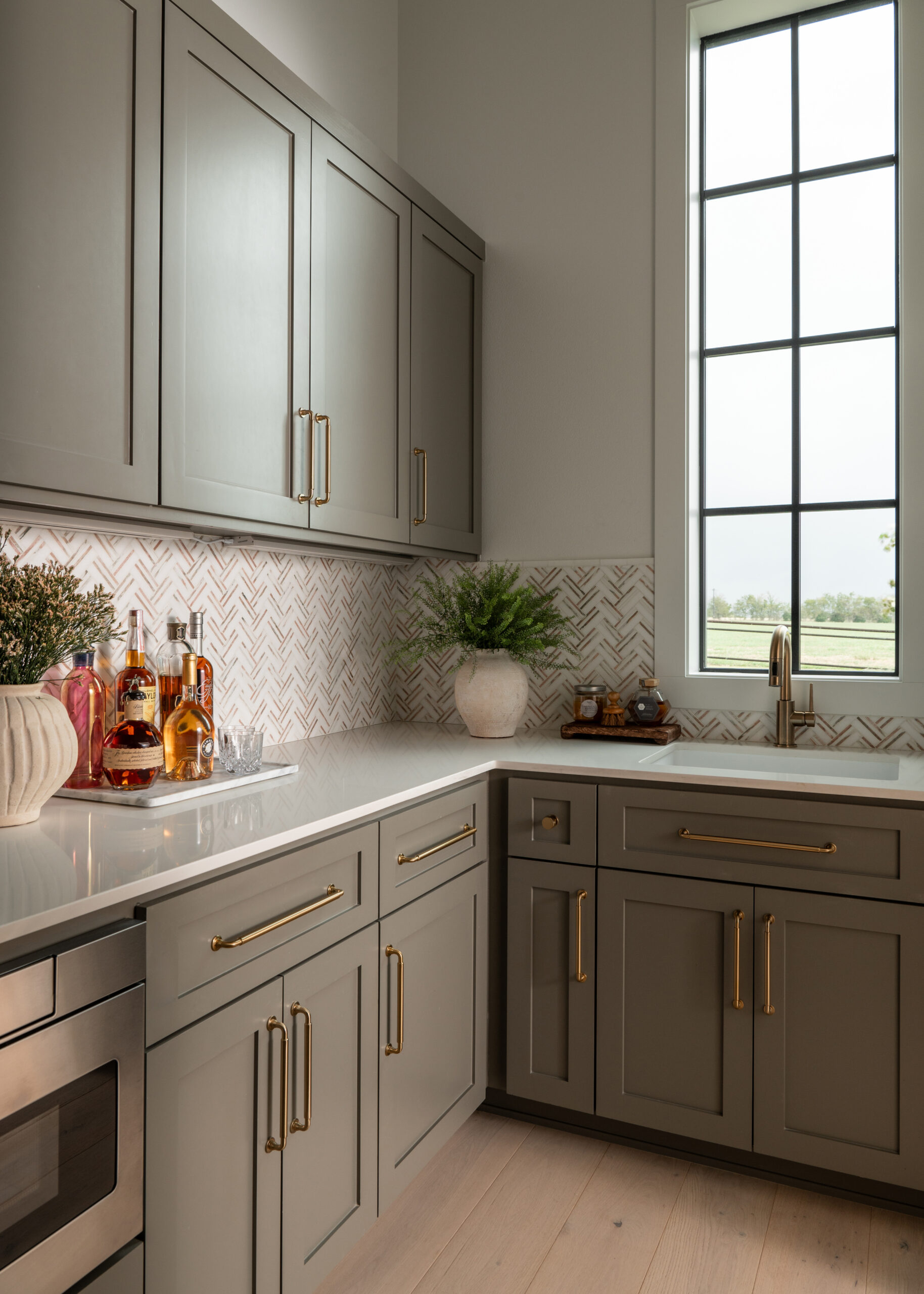 A contemporary kitchen space with a clean and streamlined design, featuring a marble island and minimalist cabinetry.