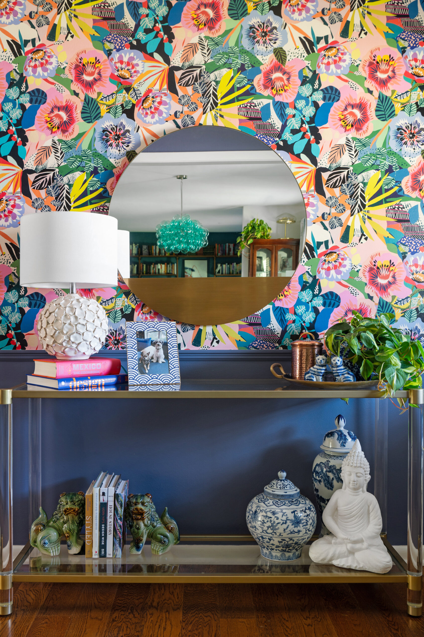  A lively home bar area with vibrant floral wallpaper and eclectic décor, ideal for interior design publications focusing on playful, colorful spaces.